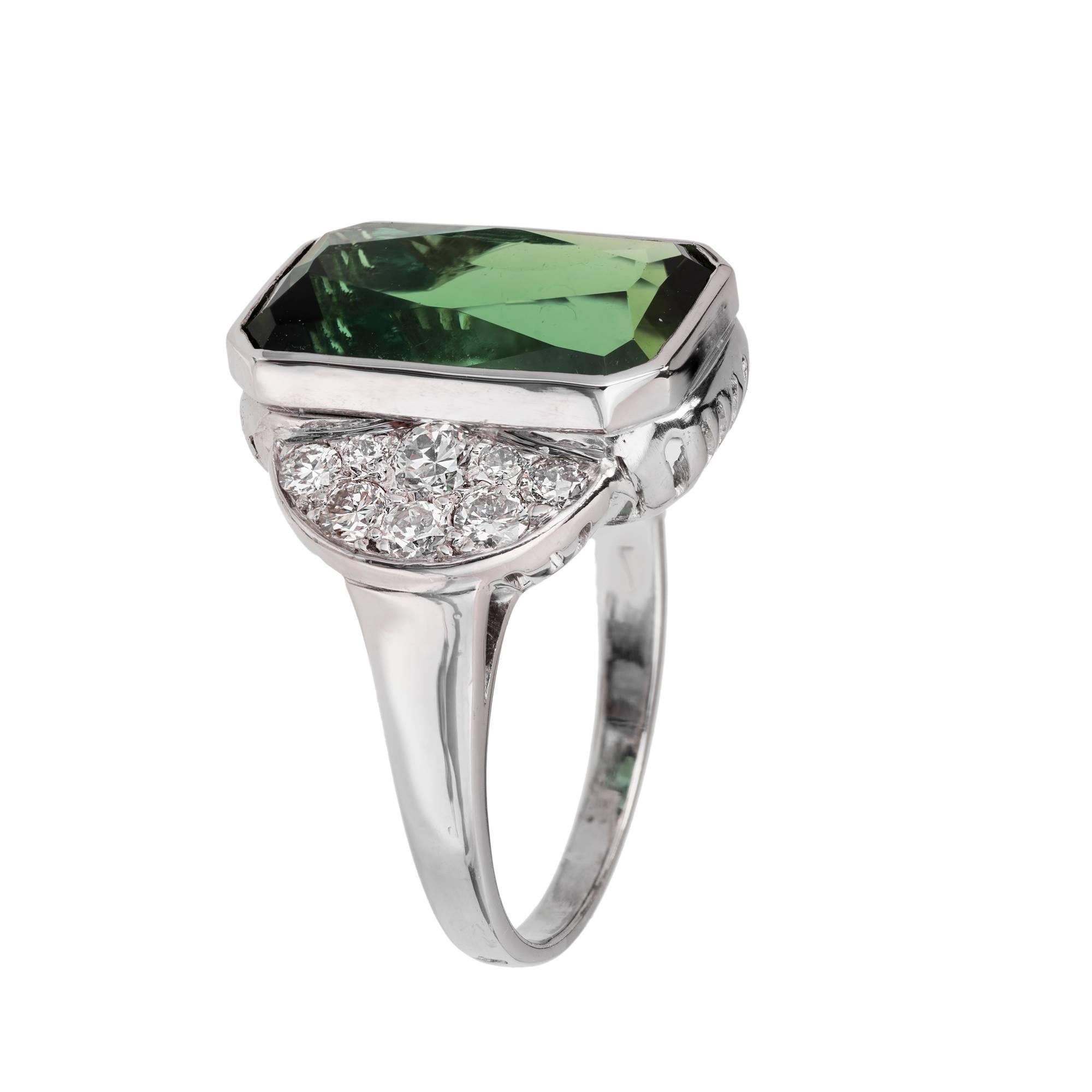 Vintage 1950-1960 octagonal elongated green Tourmaline and diamond ring. 7.46ct center tourmaline with 16 full cut Pavé Diamonds in a platinum setting. Gubelin certified as natural Tourmaline.

1 octagonal bright green natural Tourmaline, approx.