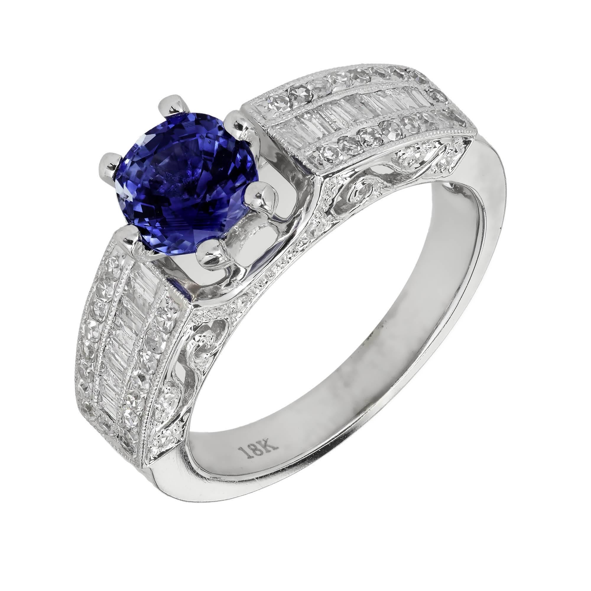 Vivid bright blue oval Sapphire engagement ring. 18k white gold with fine white round and baguette Diamond accents.  The Sapphire is GIA certified simple heat only natural corundum no other enhancements.

1 oval bright blue Sapphire, 6.33 x 5.75mm