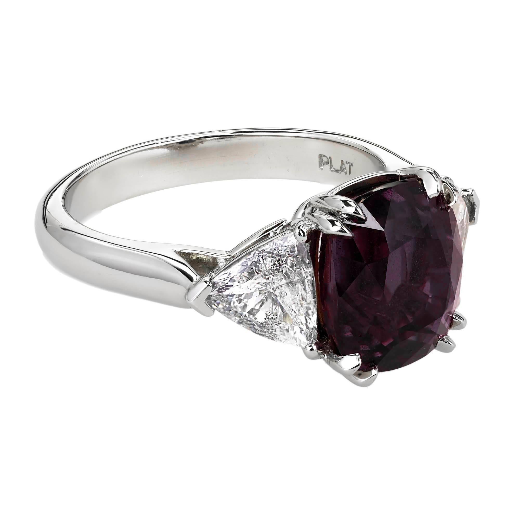 Sapphire and diamond three-stone engagement ring. Impressive, dark pink and purple GIA certified 5.69ct Antique cushion cut center sapphire, set in a three-stone platinum handmade eight prong setting, made specifically for these stones. The sapphire