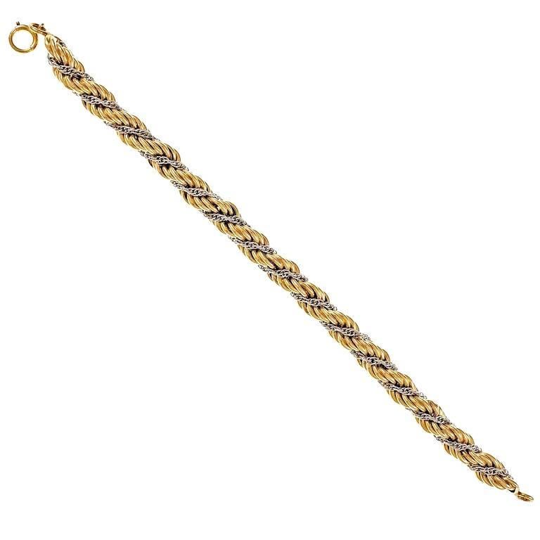 Vintage 1950s Tiffany & Co rope yellow gold bracelet with white gold center rope chain.

14k yellow gold
14k white gold
15.0 grams
Tested and stamped: 14k
Hallmark: Tiffany
Length: 7.5 inches – Width: 7.5mm – Depth: 7.5mm
