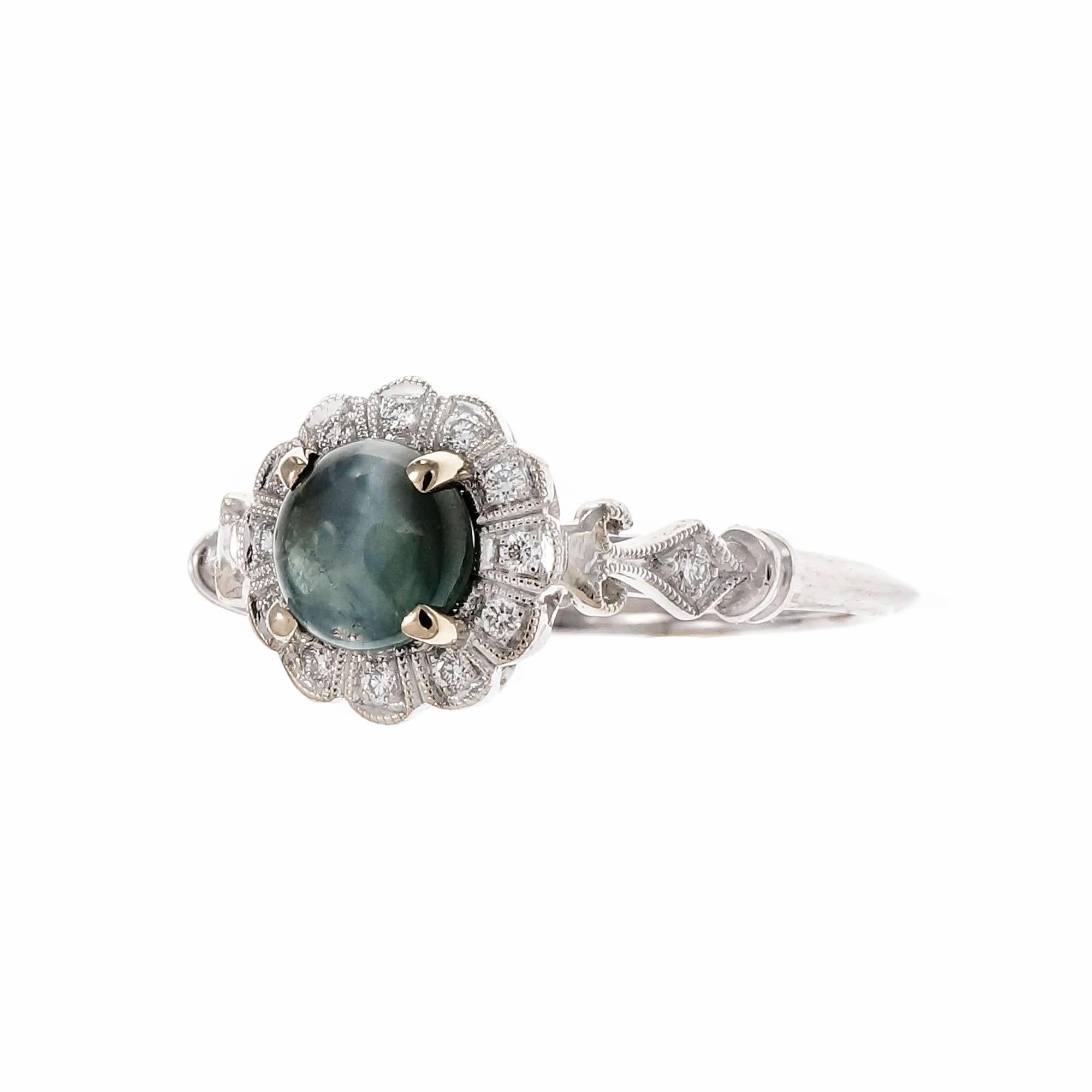 1940’s Cat’s Eye Alexandrite color change cabochon ring. Changes color from yellowish green in daylight to purplish grey in incandescent light. Center Cat’s eye as well. Delicate but strong 18k white gold ring with bright white full cut Diamond