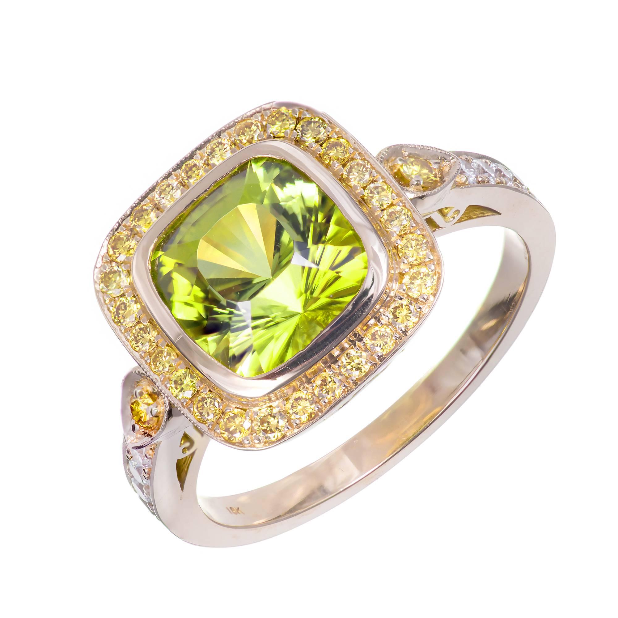 Peter Suchy original design ring with natural fancy yellow Diamonds surrounding an extremely special and rare estate Tourmaline. The Tourmaline is AGL certified as natural and untreated of yellow green Peridot like color. The center stone is from an