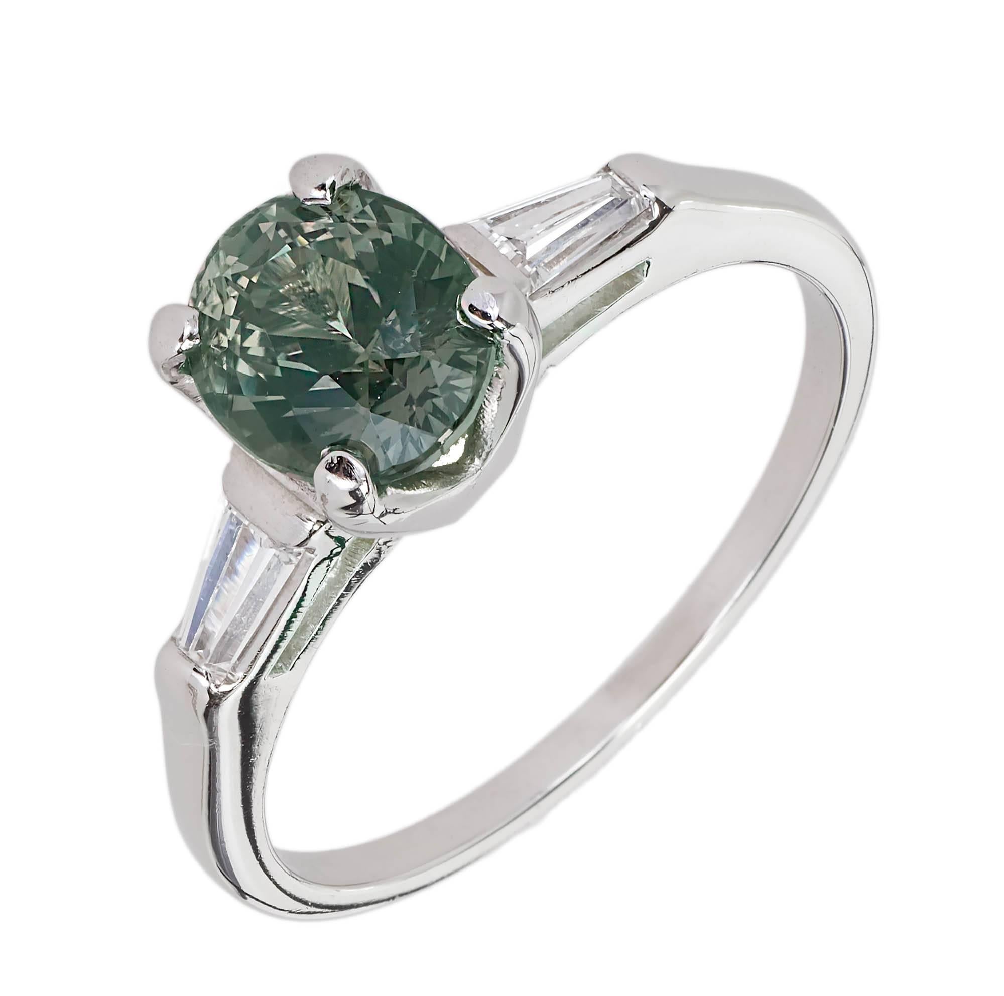 Vintage Alexandrite Platinum engagement ring circa 1950 in a classic setting with tapered baguette Diamond accents. GIA certified Alexandrite center that changes color from green to grayish purple in different lights.

1 oval genuine green to