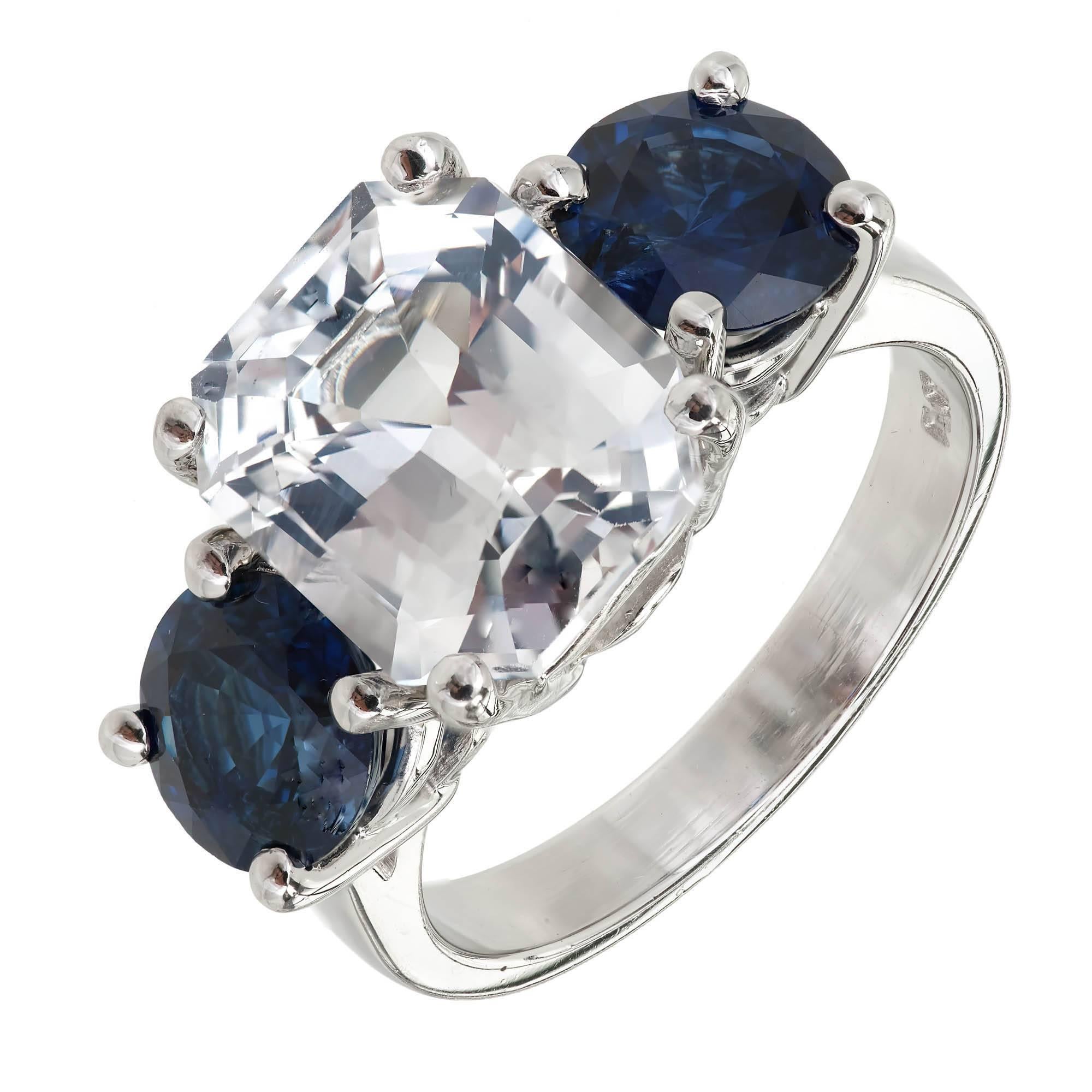 Octagonal step cut three-stone Sapphire engagement ring. Natural color no heat no enhancements and GIA certified center stone. Very light blue with good brilliance. Fine bright blue side Sapphires with excellent brilliance 2.80cts total. In a custom