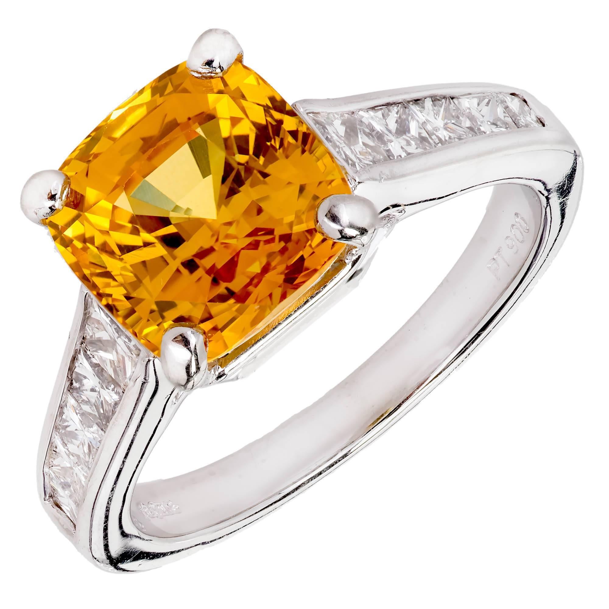 Orange cushion cut Sapphire an diamond engagement ring from JB Star. Bright yellowish orange GIA certified natural sapphire with simple heat treatment only, center stone, with 10 princess cut accent diamonds set in a platinum setting. 

1 cushion