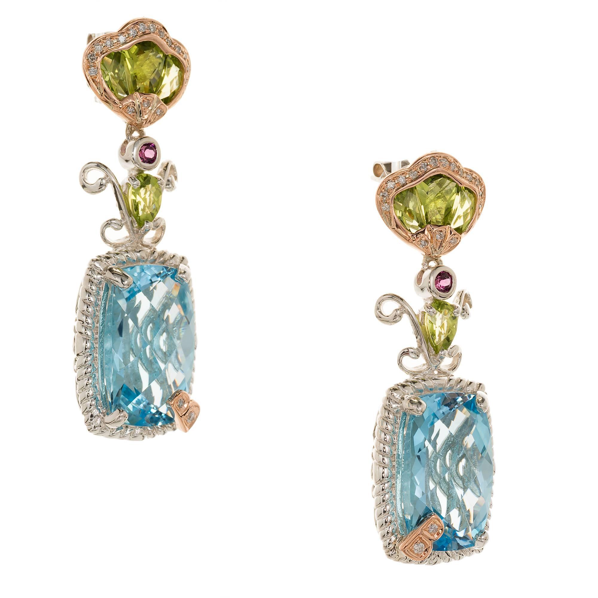 Bellarri silver and 18k rose gold dangle earrings with Peridot, diamond, blue Topaz and garnet Fully finished rear galleries.

2 blue Topaz, 15 x 11 rectangle, approx. total weight .22cts
8 custom cut Peridot, approx. total weight 1.20cts
38 round