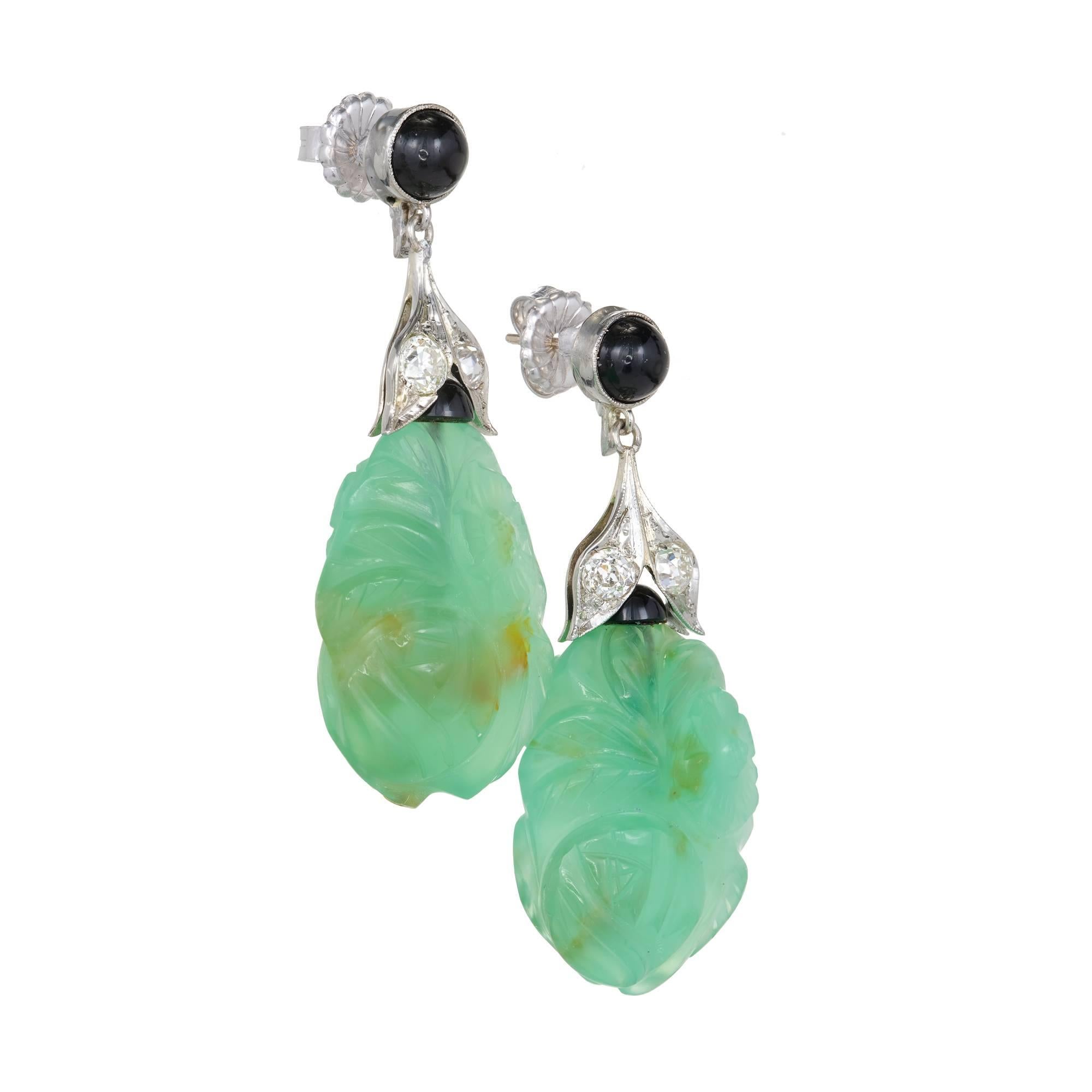 Original 1930’s late Art Deco earrings with translucent carved Chalcedony accented by black Onyx and old European cut Diamonds.

2 carved green Chalcedony, 24.7 x 18.44 x 10mm, GIA certificate #6187474086
2 round cabochon black Onyx, 5.63mm
2 round
