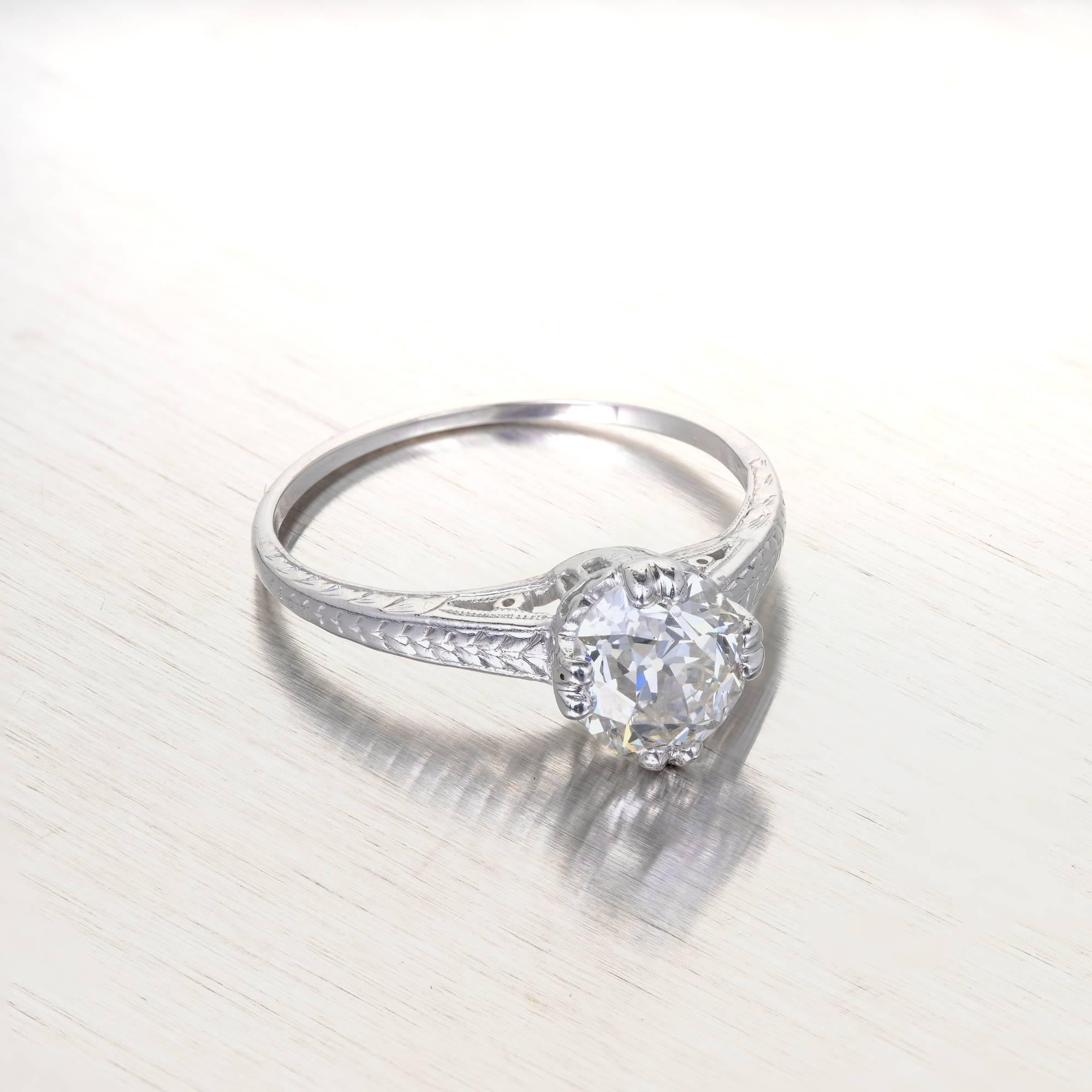 Original 1890s engraved filigree solitaire engagement ring in a platinum setting.  GIA certified as oval with old world cutting and beauty. Raised crown and small table, open culet. 

1 oval brilliant cut diamond, approx. total weight 1.28cts, I,