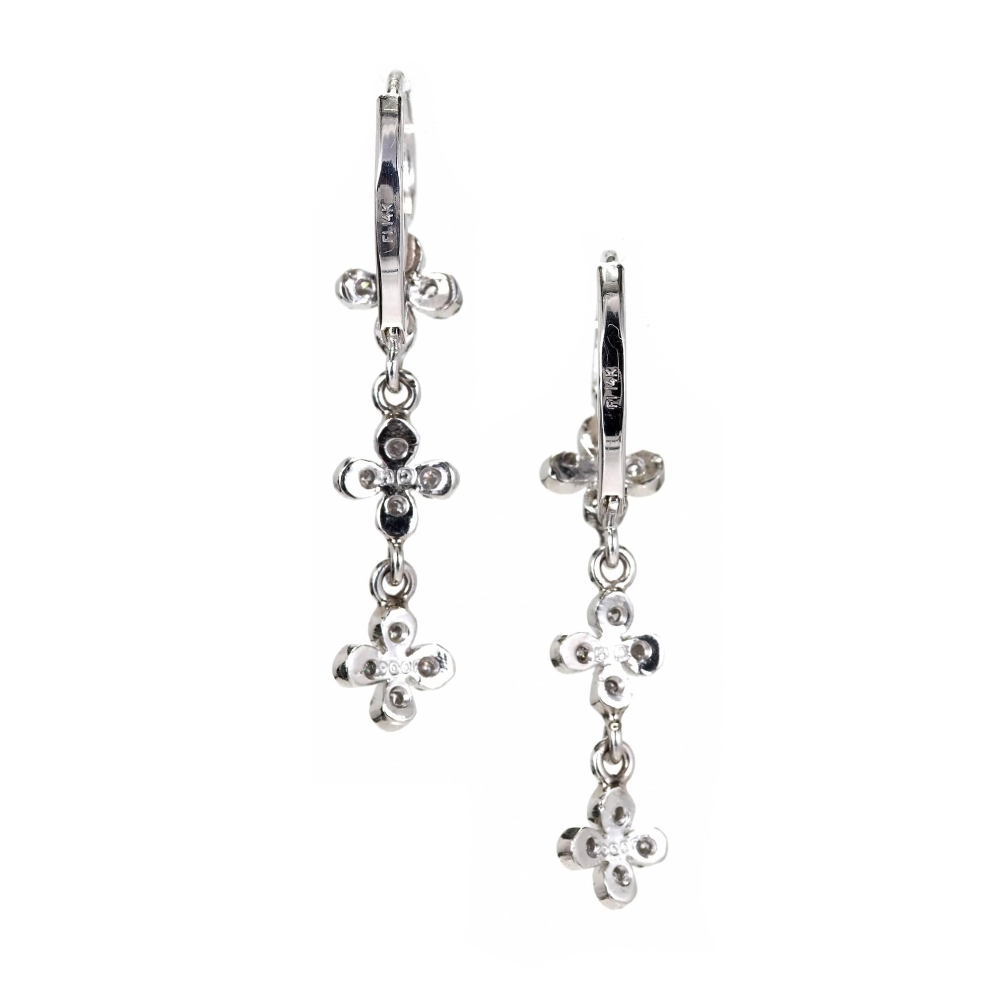 Cathy Waterman diamond triple four petal earrings. 14k white gold lever back earrings. Platinum four petal dangles.

24 full cut round diamonds, approx. total weight .15cts, F-G, VS
14k white gold and Platinum
3.8 grams
Stamped: 14k 900 P
Hallmark: