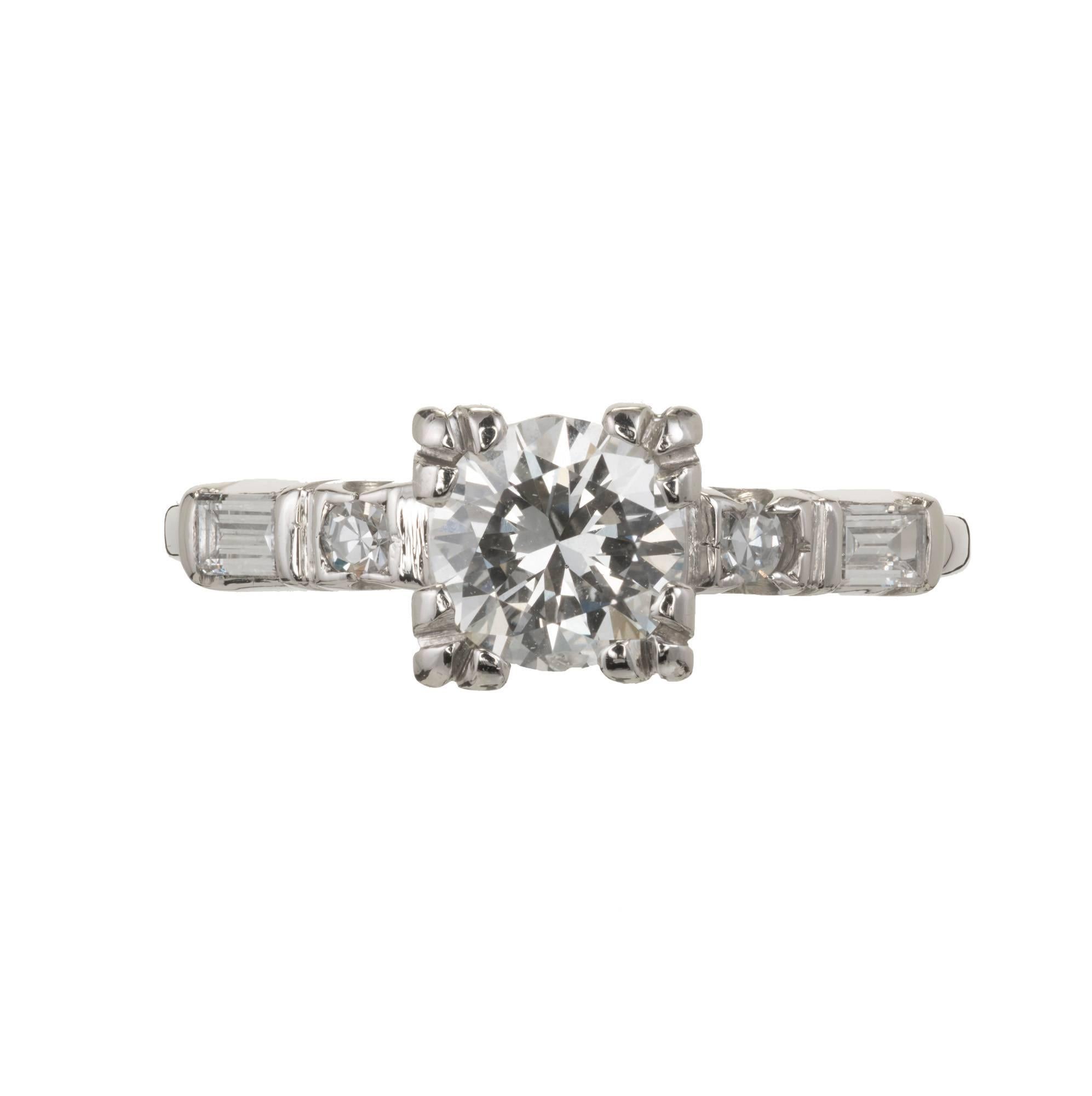 Vintage Platinum 1940s transitional cut Diamond engagement ring with baguette and round diamond accents. Square 1940’s style top with a round Diamond.

1 transitional cut Diamond, approx. total weight .75cts, G – H, SI2, EGL certificate #