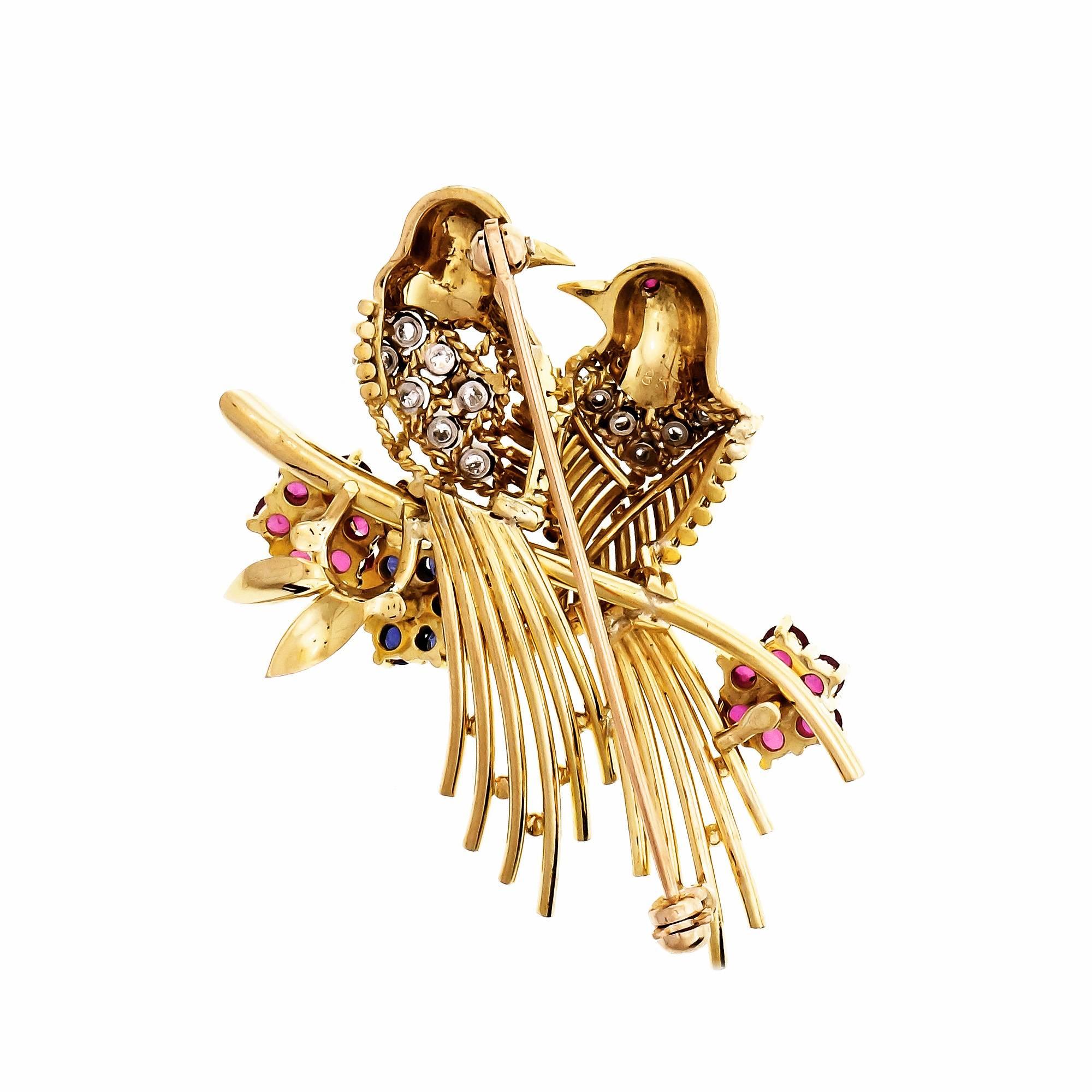  18k yellow gold Love Birds brooch set with Diamonds, Rubies and Sapphires.

18k yellow gold
15 round Diamonds, approx. total weight .38cts, G, VS
6 round fine blue sapphires, approx. total weight .50cts, SI1
14 round fine red Rubies, approx. total