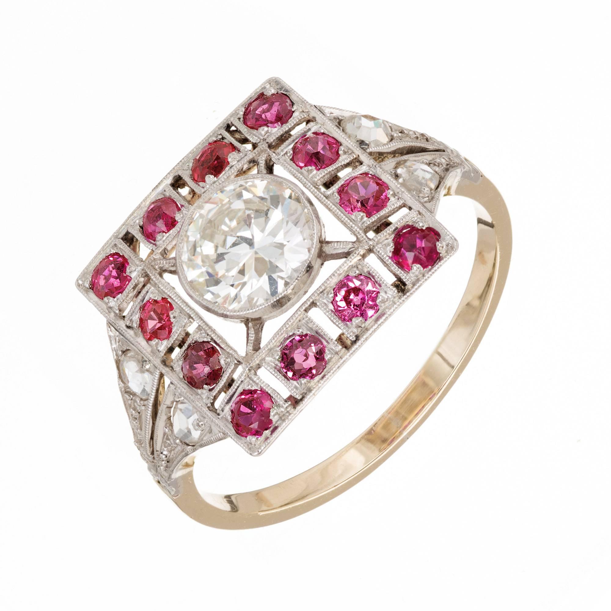Vintage 1930s Art Deco handmade cocktail ring with an 18k yellow gold base and Platinum top set with a bright sparkly center transitional cut diamond in an open work square top with natural bright pinkish red Rubies and rose cut Diamonds. 

1