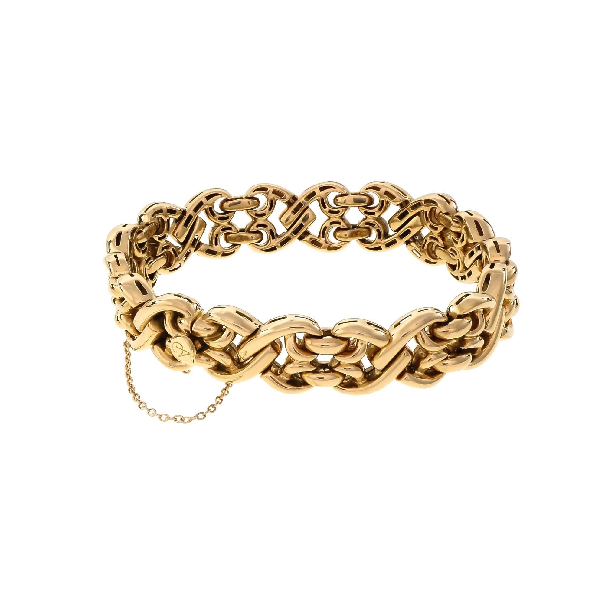 18k yellow gold heavy Italian hinged fancy link bracelet 14mm wide with built in hidden catch plus safety chain. Hallmark on the catch that we do not recognize. Circa 1970s.

18k yellow gold
Length: 7.75 inches
Tested: 18k
Stamped: 750
74.6