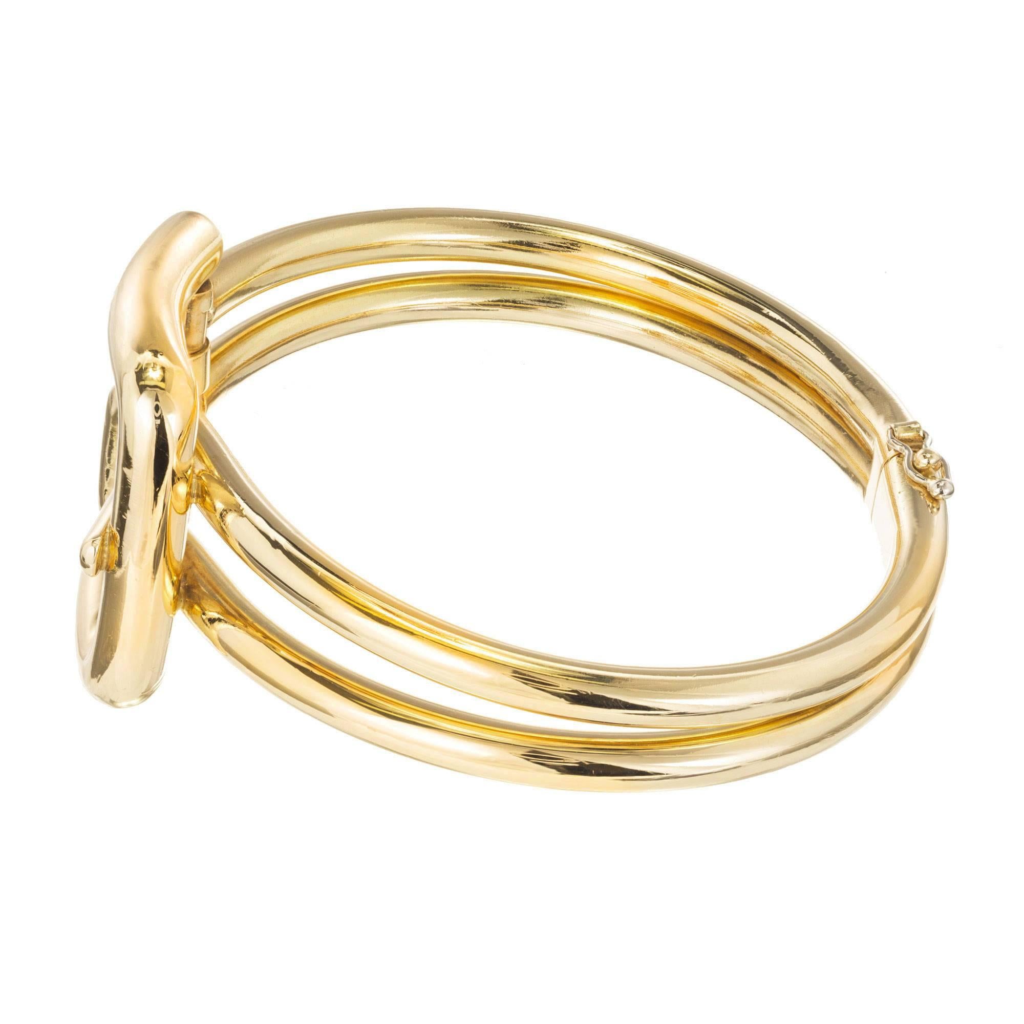 Buckle style hinged bangle bracelet circa 1950-1960. Thick heavy 18k yellow gold tubing.

18k yellow gold
fits a 7 1/2 in wrist
32.6 grams
Stamped: Italy 18k
Hallmark: MCM
Width at top: 29.42mm
Height at top: 11.97mm
Width at Bottom: 9.71mm
Tubing: