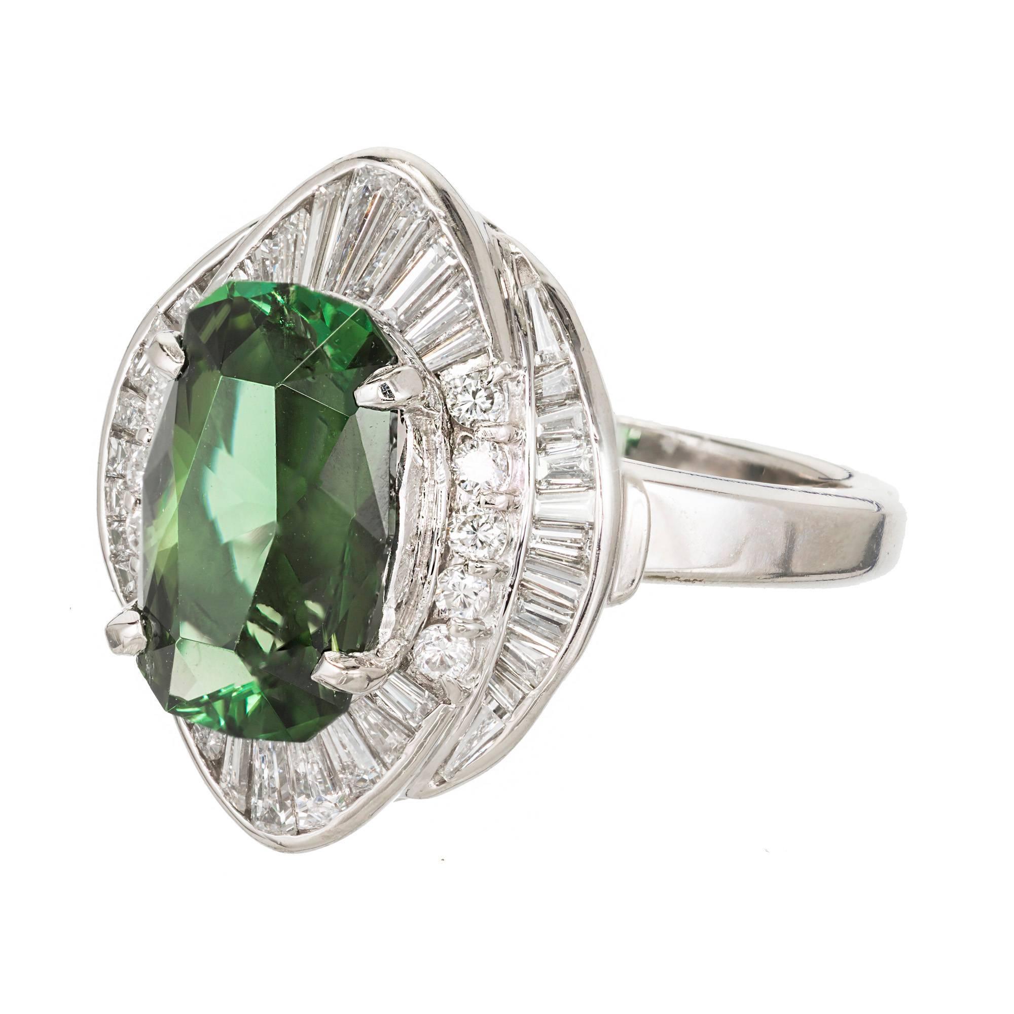 Handmade Tourmaline Diamond Princess style cocktail ring circa 1960's. Delicate wire work on the bottom of the stones. Tightly fitted custom cut diamonds surrounding a custom elongated cushion cut intense pure green Tourmaline

1 modified custom cut