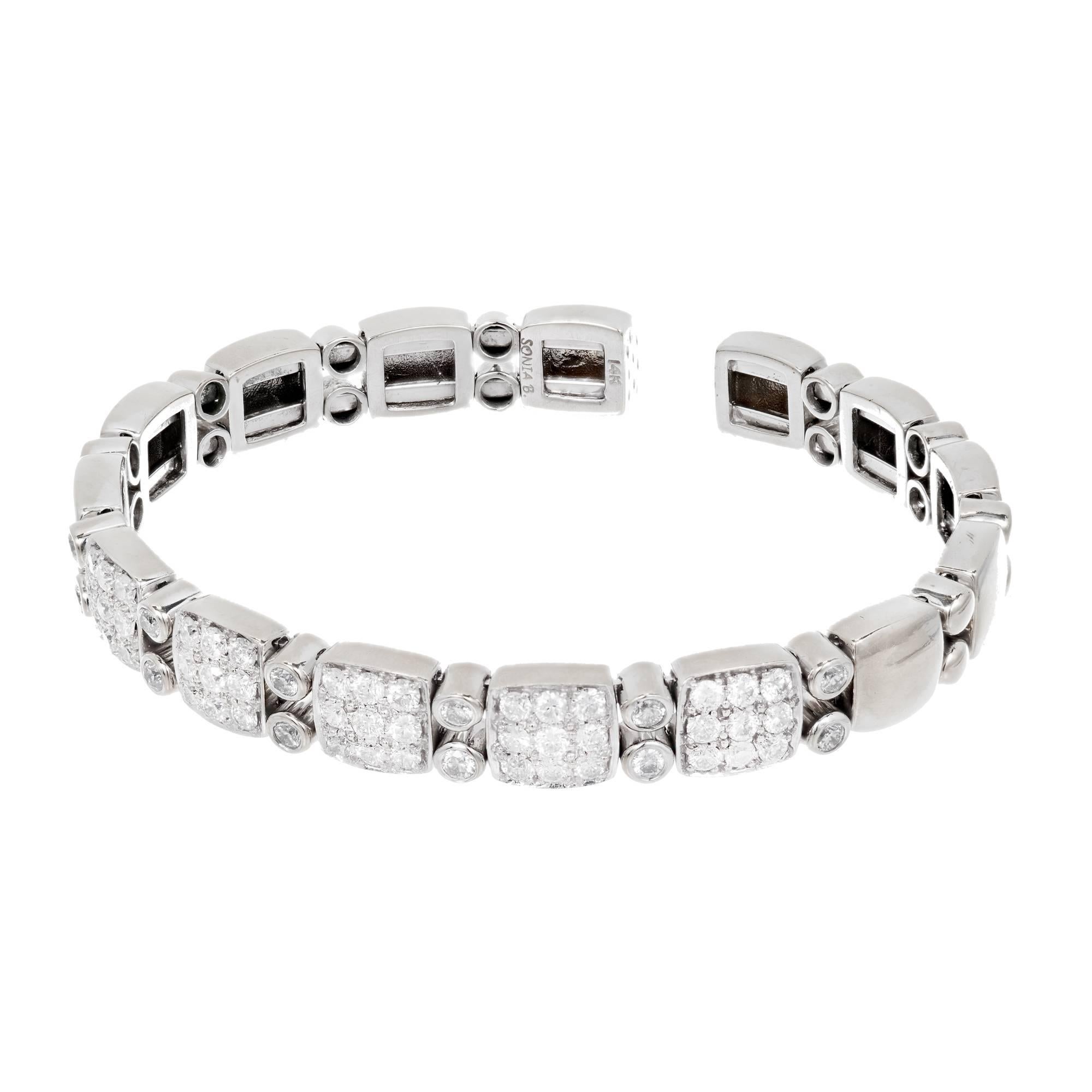 Sonia B solid 14k white gold flex bangle bracelet with fine white sparkly diamonds.

57 round full cut diamonds approx. total weight 1.70cts, H, VS1 to SI1
29.3 grams
14k White Gold
Stamped: 14k Sonia B
Open bottom and oval shape
Width: 3/ inch or