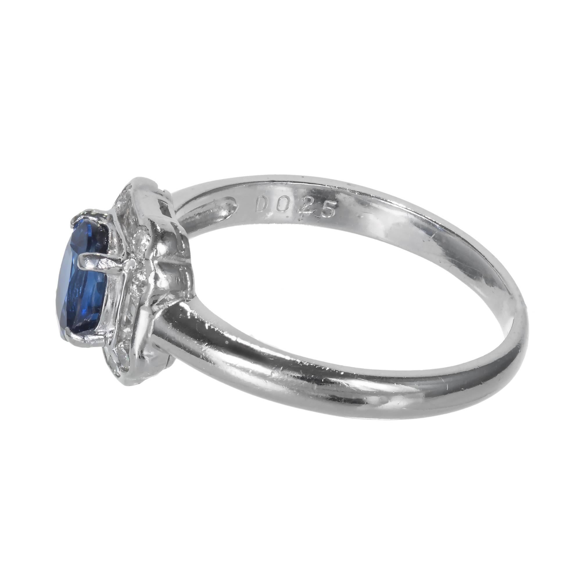 1940’s Retro Deco Style bright Ceylon oval Sapphire engagement ring surrounded by diamonds in a platinum setting.

1 oval sapphire .80cts.
8 round diamonds approx. total weight .25cts, F, VS.
Size 6 and sizable
Platinum
Stamped Platinum D 0.25