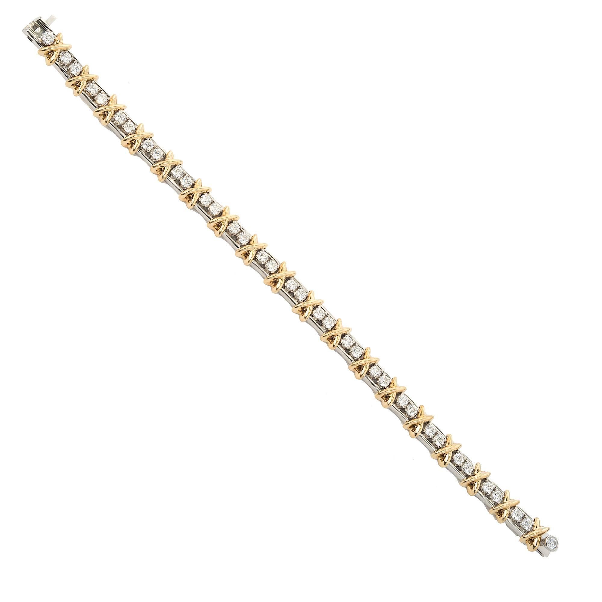 Tiffany & Co Schlumberger 36 Stone Diamond Bracelet in Platinum and 18K yellow gold with the iconic X pattern. Ideal full cut diamonds 2.95 carat F VS

36 round full cut diamonds F VS approximate 2.95 carats
Platinum
18k Yellow Gold
Tested: Platinum
