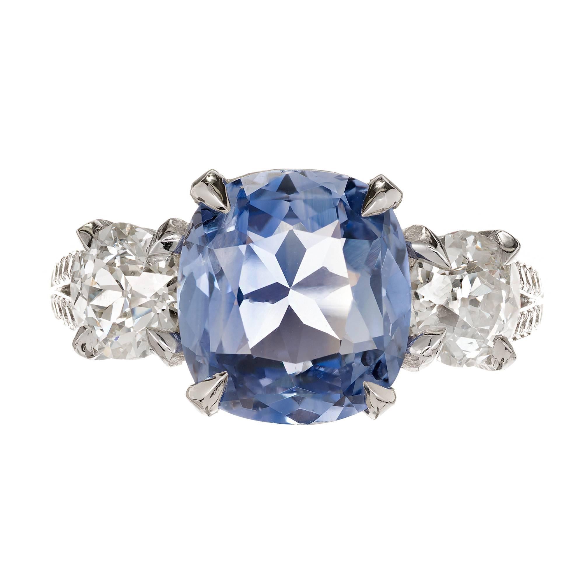 Peter Suchy split shank three-stone sapphire and diamond engagement ring. The center light blue bright Sapphire is Antique cushion cut with a periwinkle overtone. Moderately included. The Diamonds are bright sparkly old mine cut. GIA certified. 

1