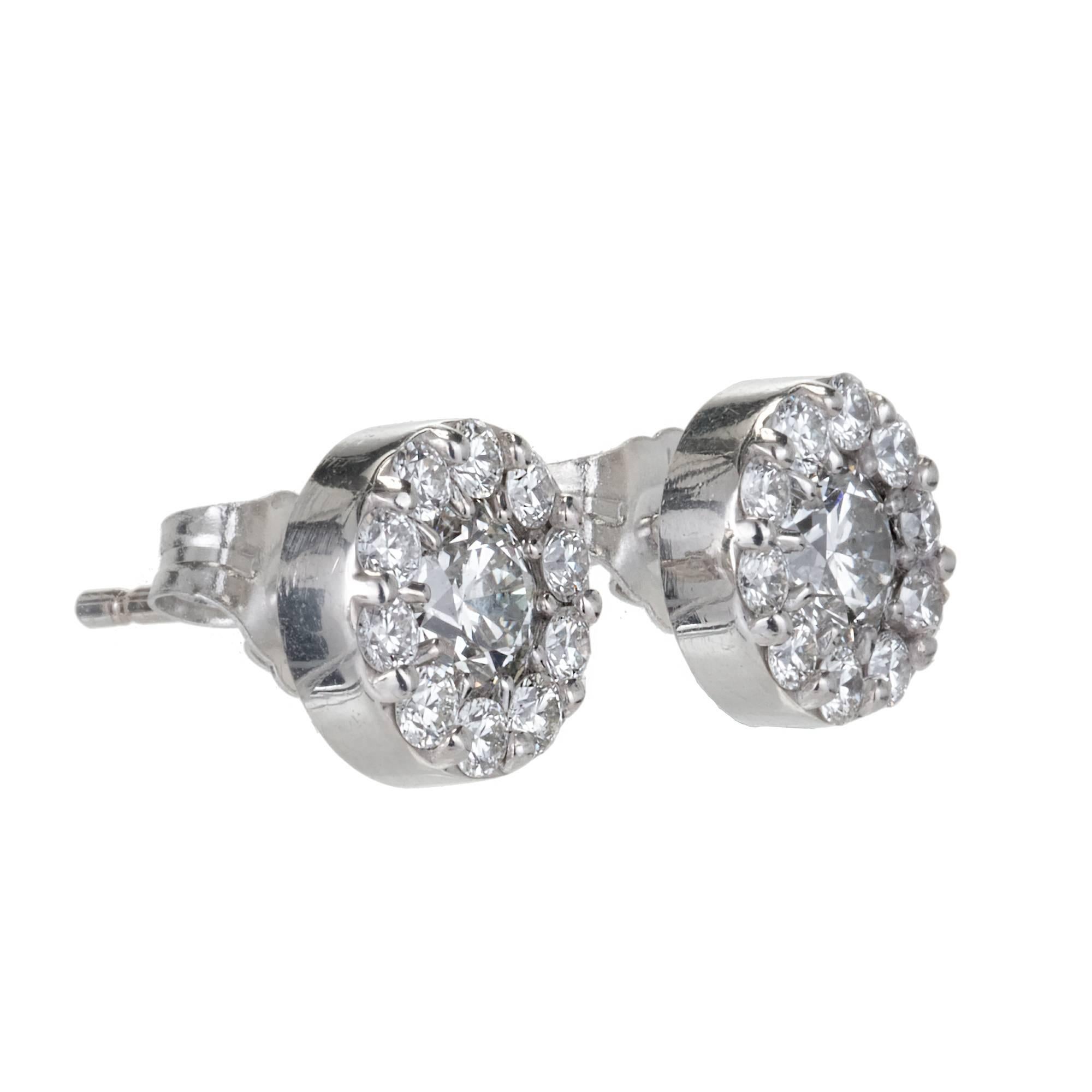 Halo 7mm round diamond cluster stud earrings  
1.00ct total weight.

2 round brilliant cut diamonds, .50ct. total weight H, VS
20 round full cut diamonds, approx. total weight .50cts, H, VS
18k white gold
2.1 grams
Tested: 18k
Stamped: 750
