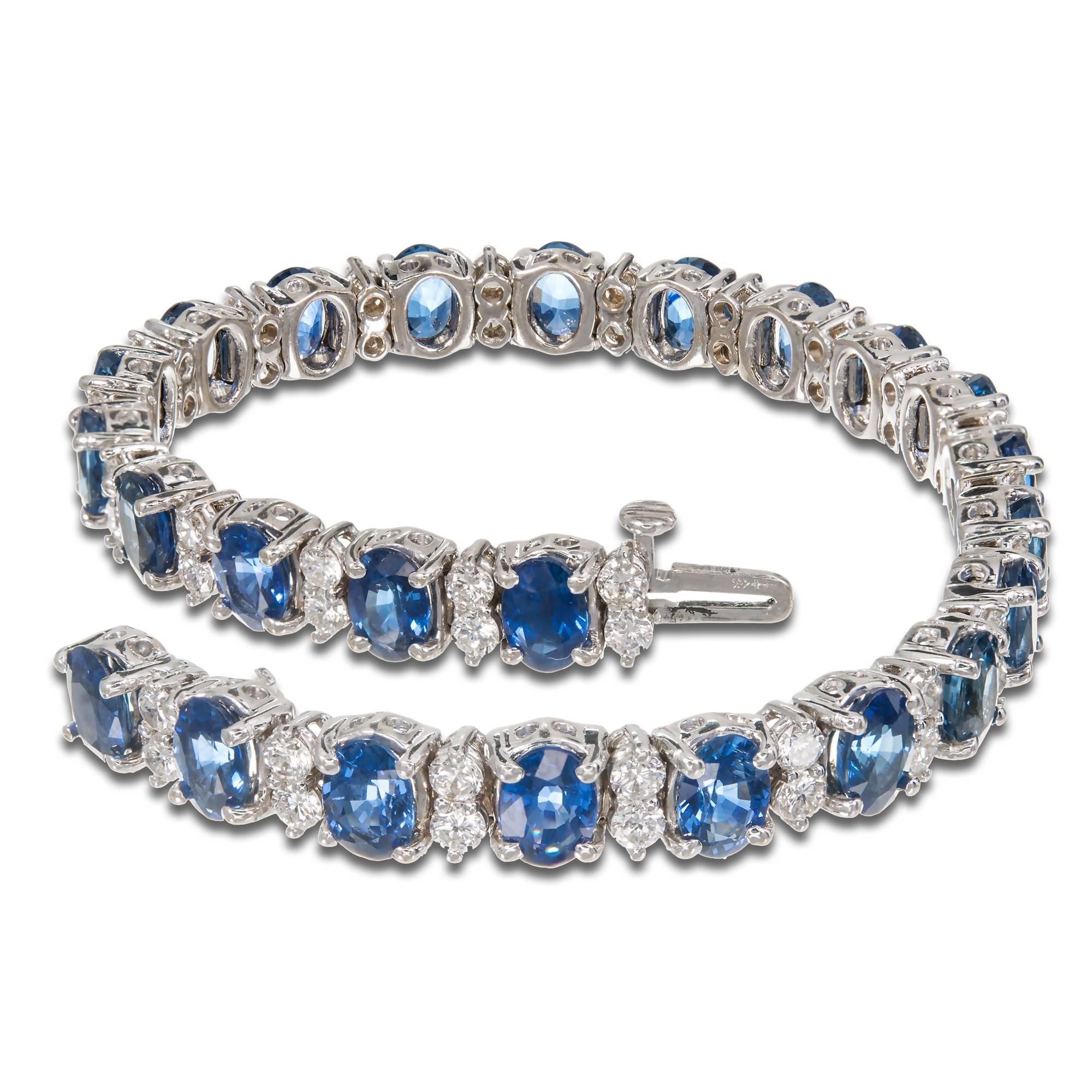 Hinged link 18k white gold bracelet with top cornflower blue bright sapphires and well cut fine white diamonds. Hidden catch and underside safety.

24 fine blue sapphires, approximately total weight 15.60cts, 6 x 4.4mm
48 full cut diamonds,