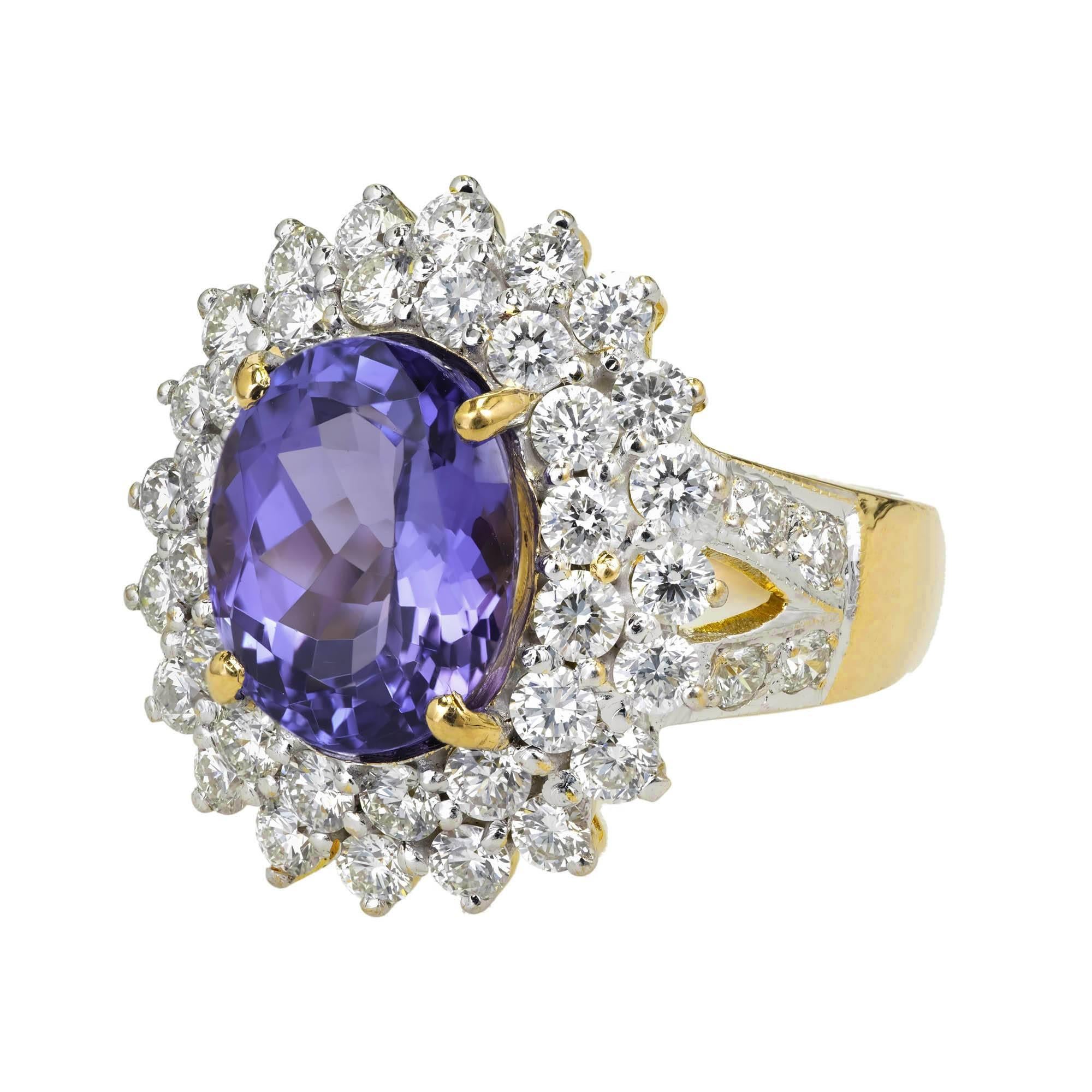 Purple blue Tanzanite 2 row cluster halo diamond ring. In a handmade 18k white and yellow gold setting.

1 oval fine bright purple blue Tanzanite, approx. total weight 5.17ct, VS, 11.2 x 9.1mm
42 round full cut diamonds, approx. total weight