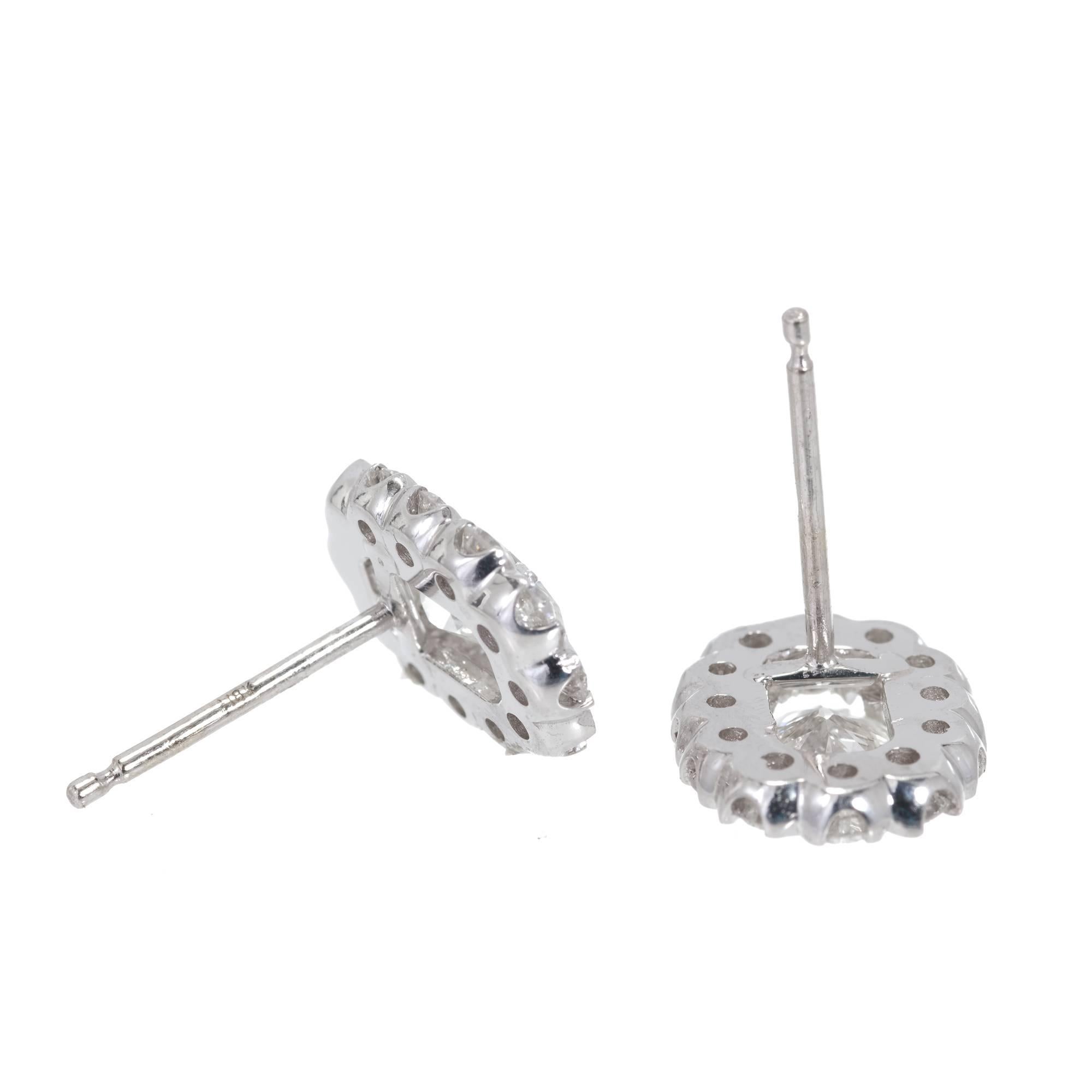 Simple antique style diamond halo design 14k white gold earrings. Halo design with top quality full cut diamonds held in place by small V sections surrounding the center stone. In this case the tops are oval surrounding the center stones which are