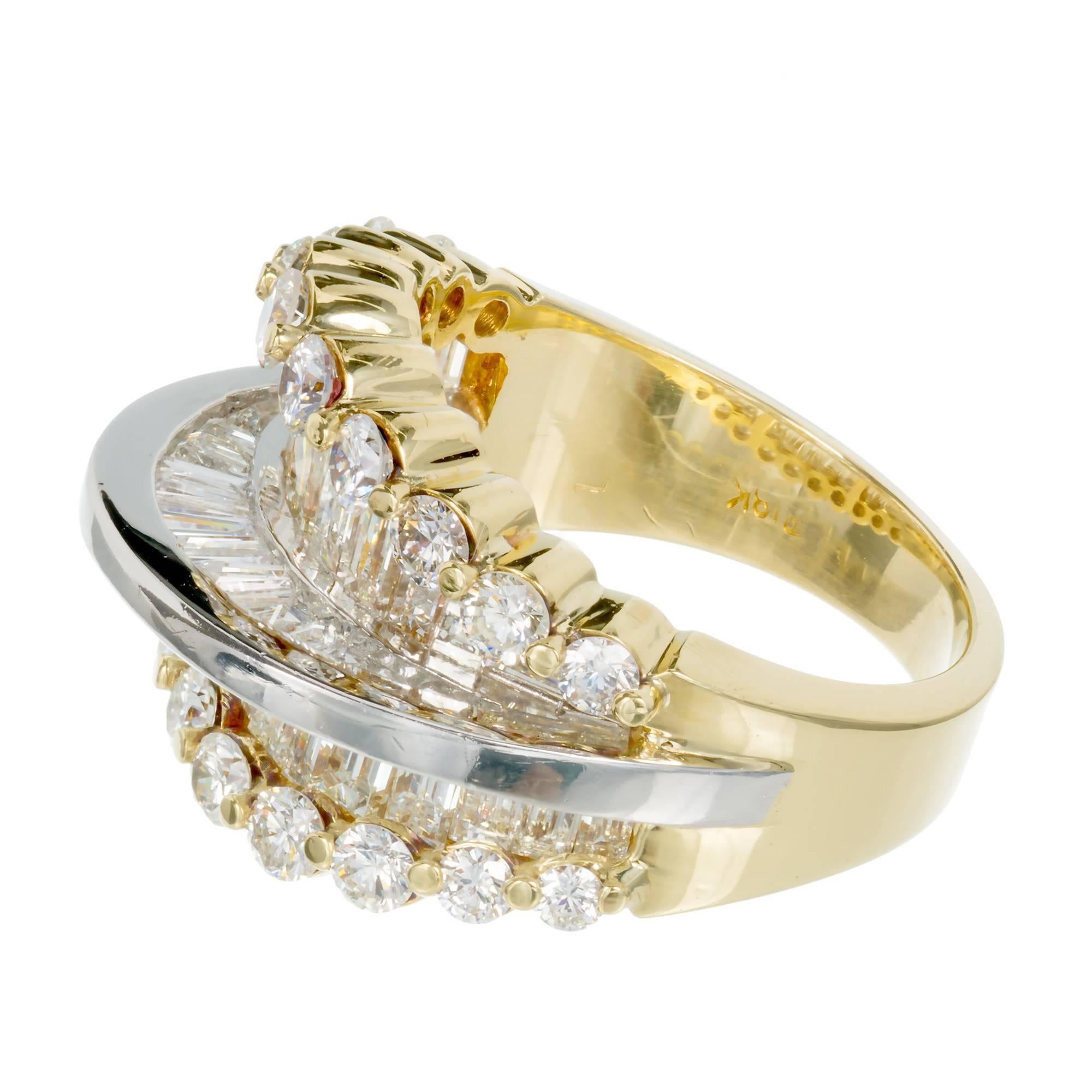 18k yellow gold multi diamond ring combining baguettes and round diamonds in a prong setting. Center bar is white gold. Baguette diamonds are set on both sides of raised center bar. Circa 1960.

20 round diamonds approx. total weight 1.10cts E-F,