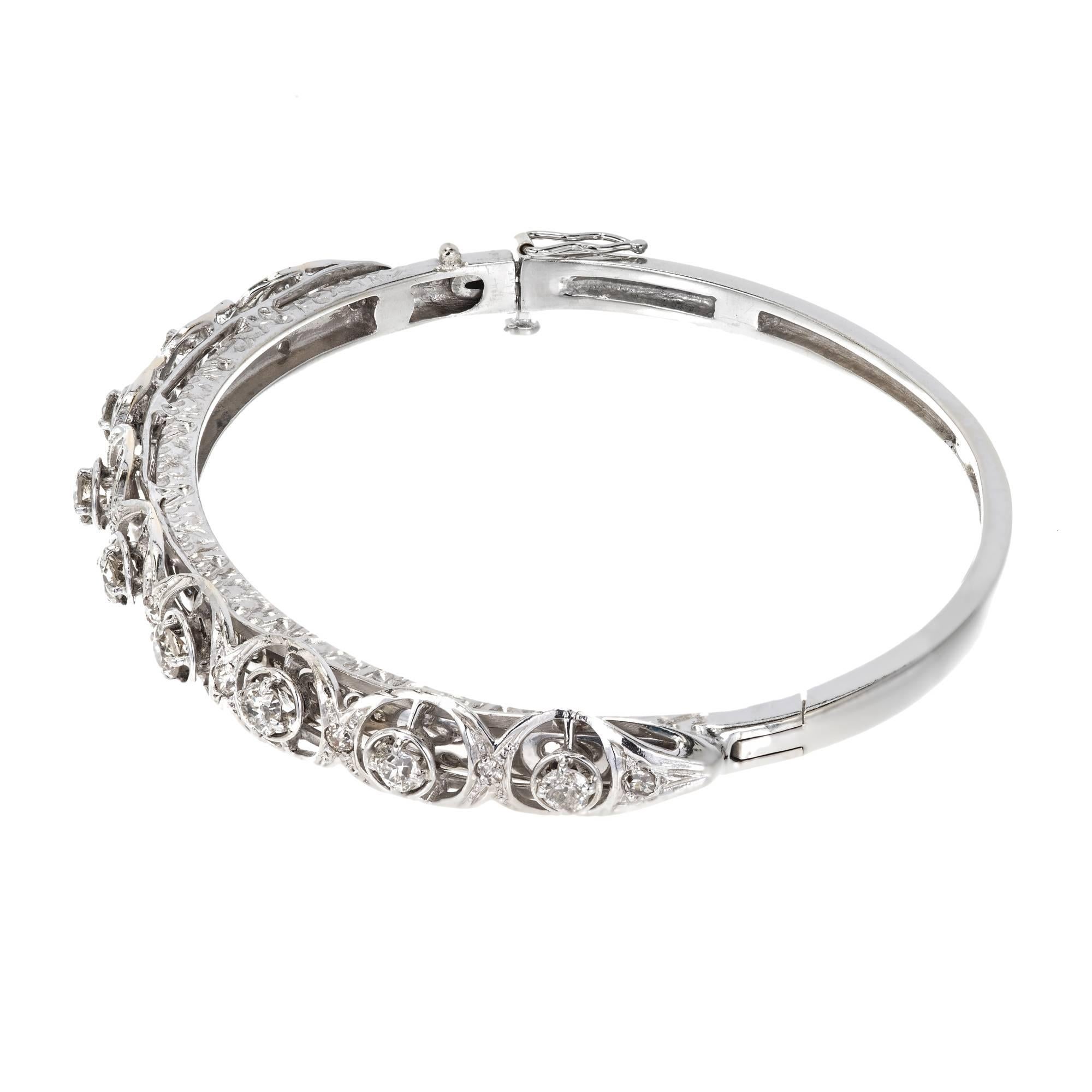 Solid 14k white gold bangle bracelet. The open work top is bead and prong set with old European cut diamonds that are bright and sparkly. The bracelet is solid with hinge catch and figure 8 safety working well. Circa 1940-1950.

9 old European cut
