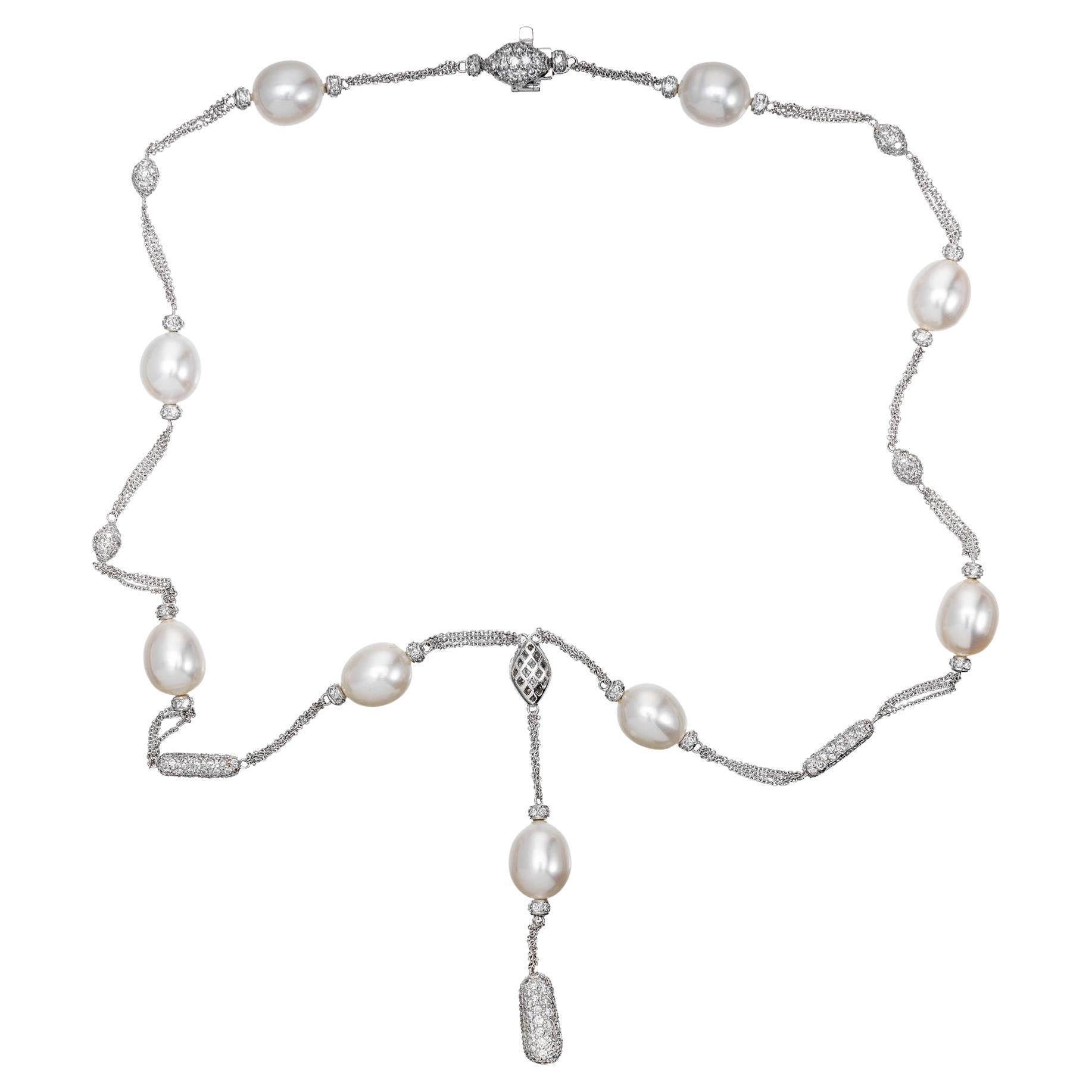 Pearl and diamond drop necklace. 9 freshwater peals with pave set diamond roundels on each side of the pearls. Diamond pave set ovals and bars are stationed in between the pearls with a larger diamond pave oval, bar and pearl drop at the center of