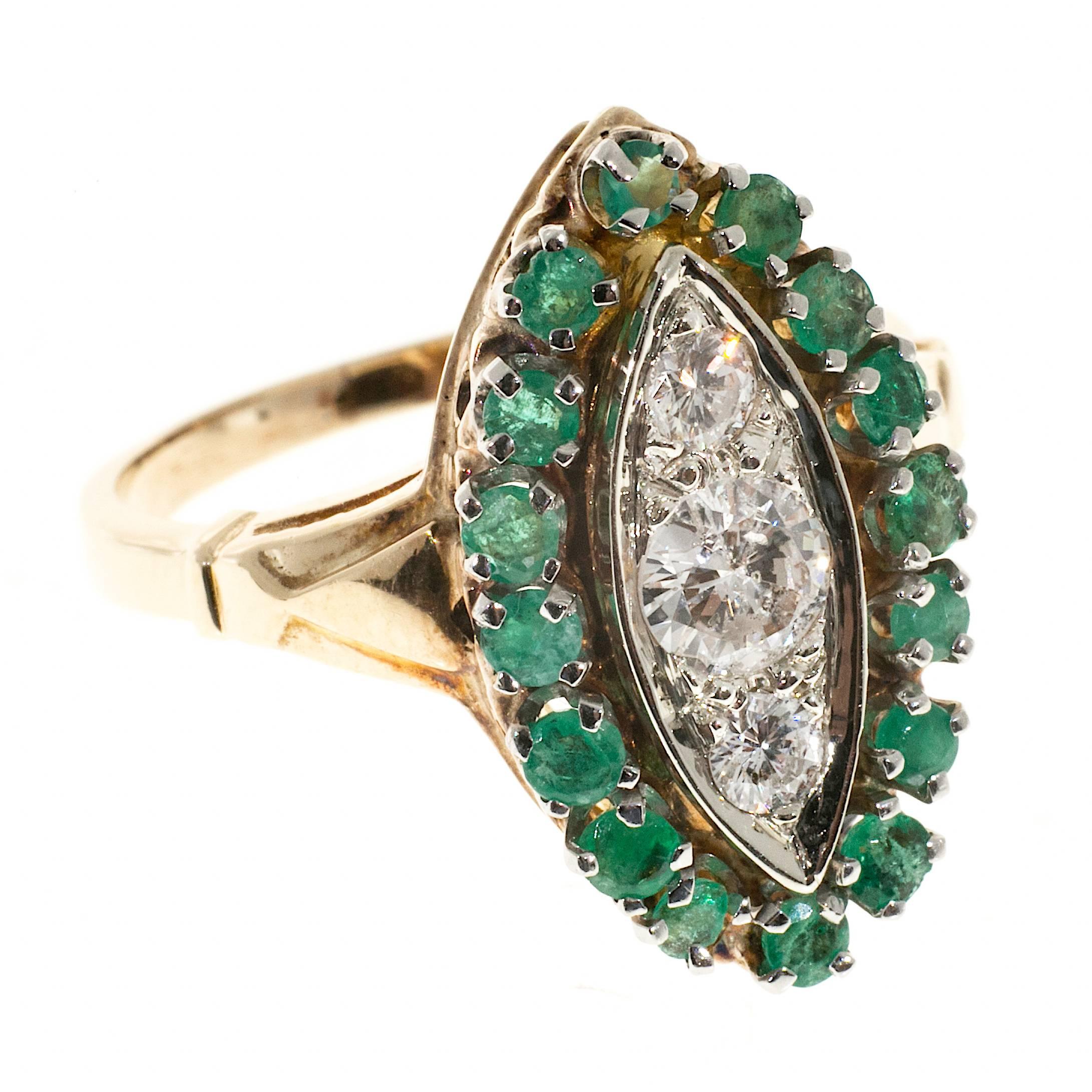 Original 1950’s 14k yellow gold ring with a row of bright medium green emeralds and three bright white diamonds in a white gold section.

3 round diamonds approx. total weight .64cts
Size 8 and sizable
14k Yellow and White Gold
Stamped 14k
7.9 grams
