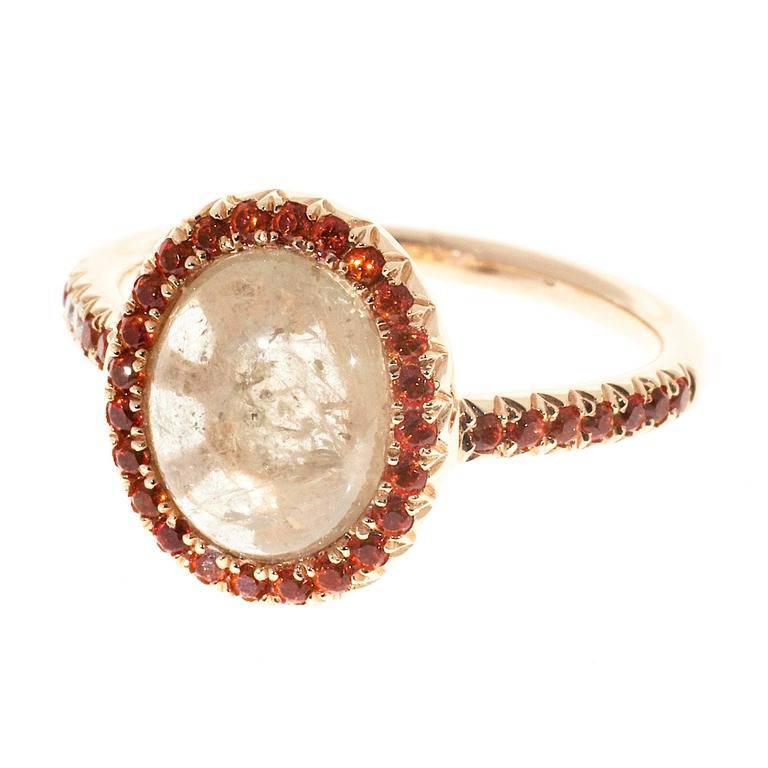 Natural untreated Sapphire engagement ring. Center stone surrounded by diamonds and orange Sapphires in a 18k rose gold setting.  

36 round orange Sapphires, approx. total weight .40cts, simple heat only
2 round diamonds, approx. total weight