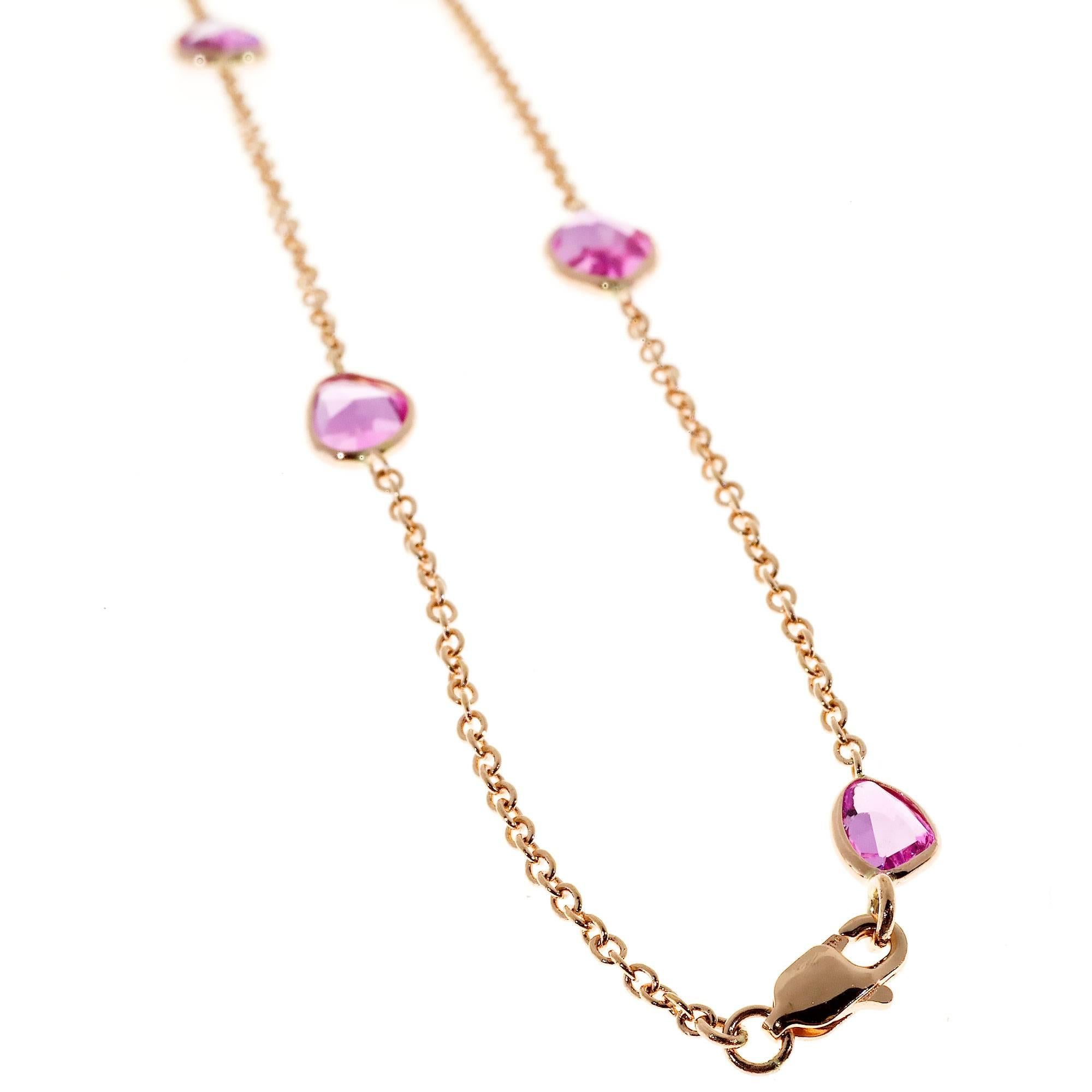 Nine bright pink genuine Sapphires. multi-shaped stones faceted top and bottom in a a rose gold chain.  Made in the Peter Suchy Workshop. PSD.

9 pink faceted irregular genuine Sapphires, approx. total weight 7.00cts, VS - SI, 6mm at widest,