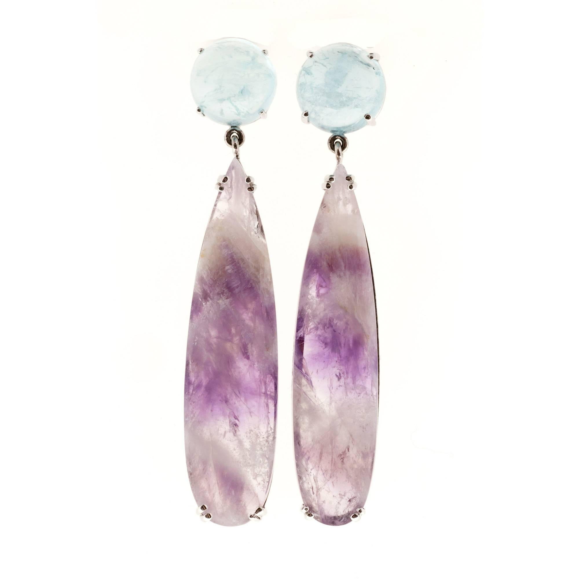Aqua and Amethyst dangle earrings. Handmade 18k white gold dangle settings from the Peter Suchy Workshop made with natural round Aquamarine and pear shaped Amethyst Quartz.

2 round genuine untreated Aquamarine, 10.7mm, approx. total weight