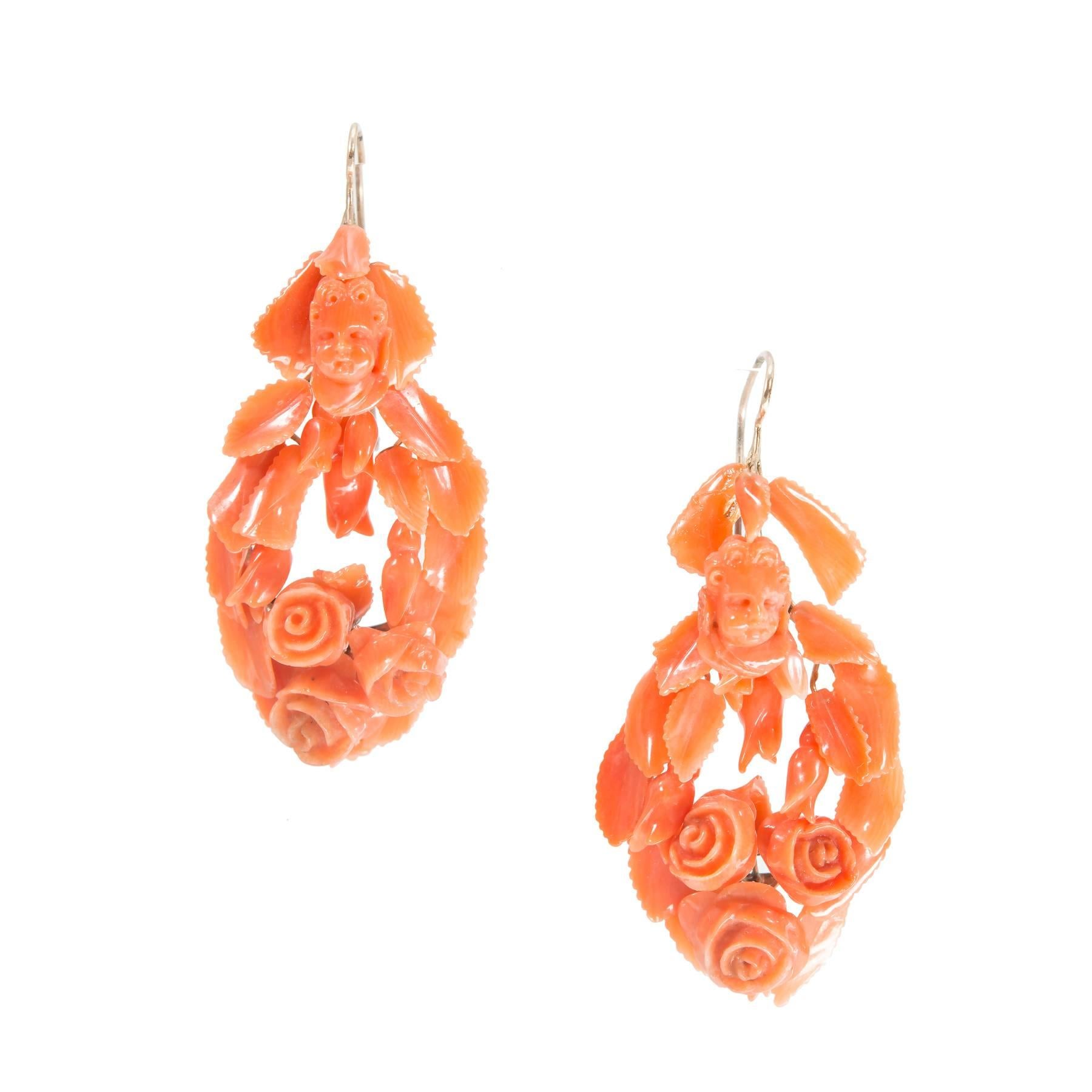 Victorian natural  carved Coral dangle earrings. All natural Coral. Circa 1800's.

48 pieces of natural carved Coral, 2 Angel’s faces, flowers and leaves
Tested: 14k gold
9.7 grams
Depth: 11.52mm
Top to bottom: 49.97mm or 1.96 inches
Width:
