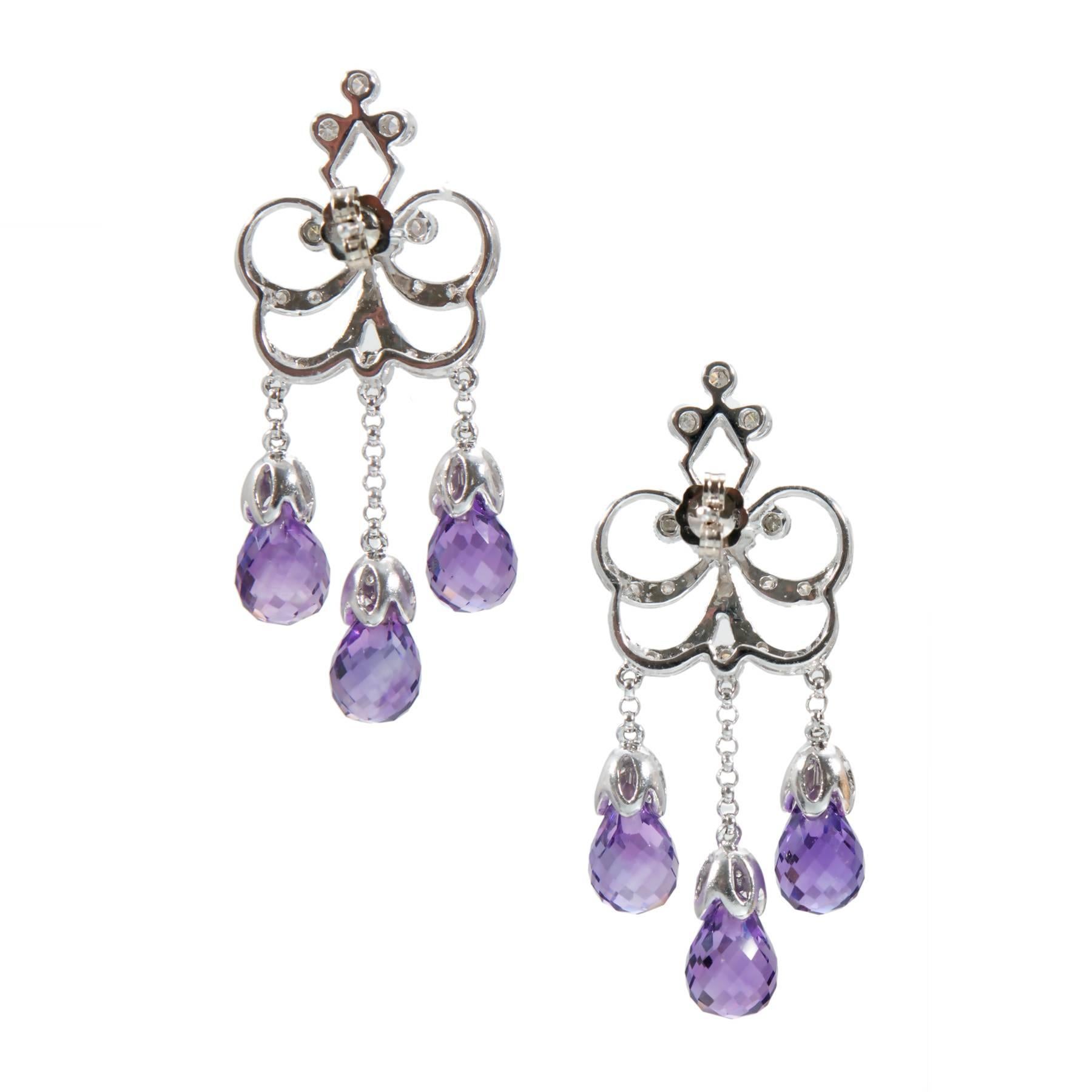 Victorian Style 14k white gold dangle earrings with diamonds and briolette Amethyst.

Six briolette cut genuine purple Amethyst 9 x 6mm, approx. total weight 12.00cts
52 round full and single cut diamonds, approx. total weight .50cts, H, SI1 to