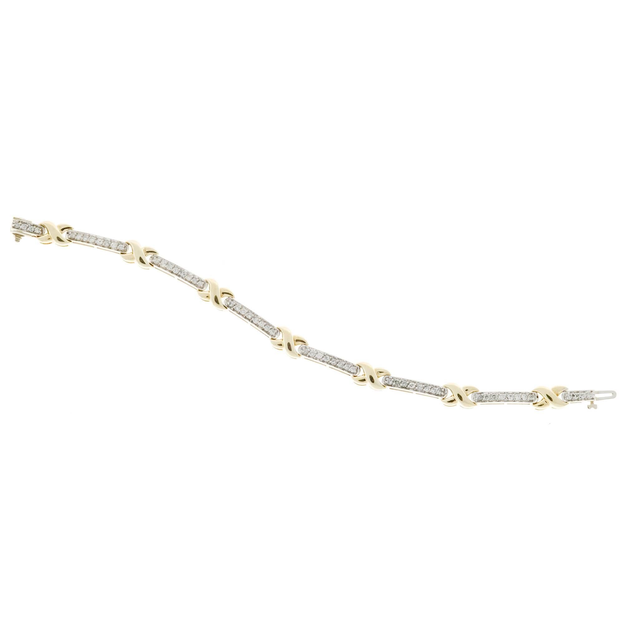 Bright and sparkly 14k white and yellow gold hinged link bracelet with full cut diamonds bead set in white gold bar links with yellow gold 