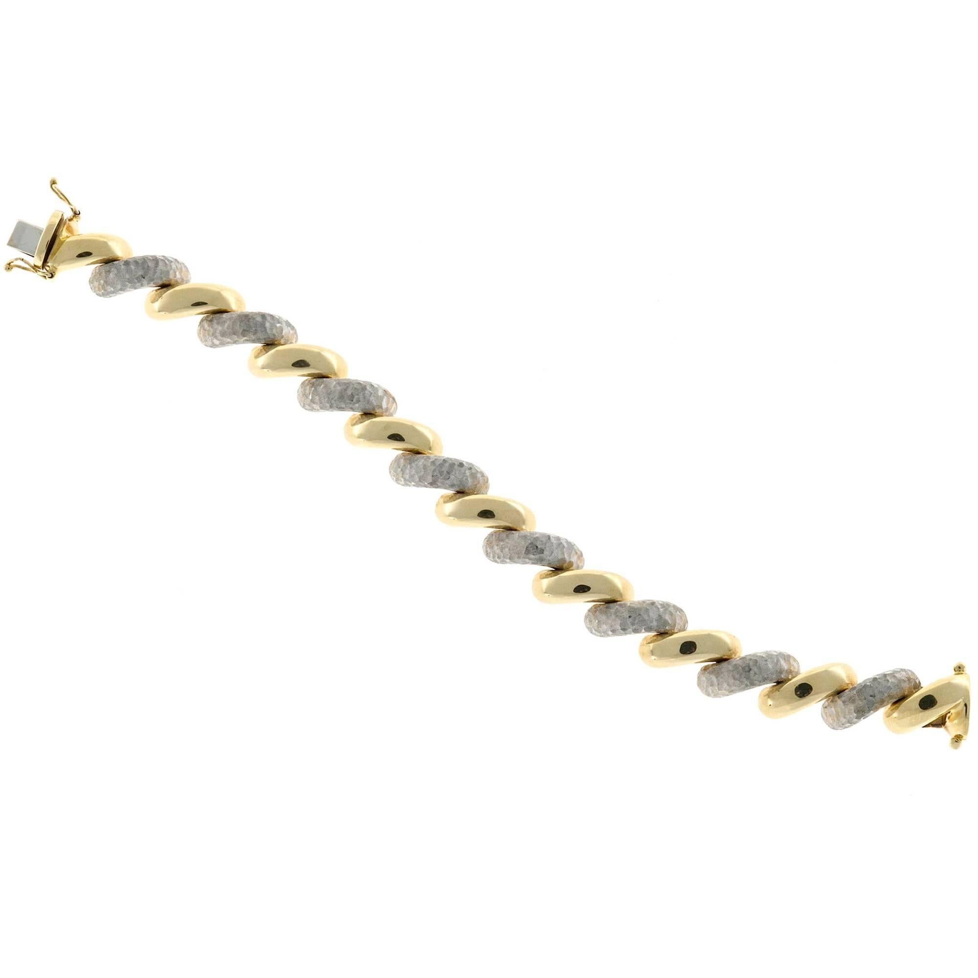 OTC Italy 18k yellow shiny and white textured San Marco link bracelet.

18k White Gold
18k Yellow Gold
37.0 grams
Stamped: 18k Italy OTC
Length: 7 1/2 inches
Width: 12.2mm
Depth: 6.15mm