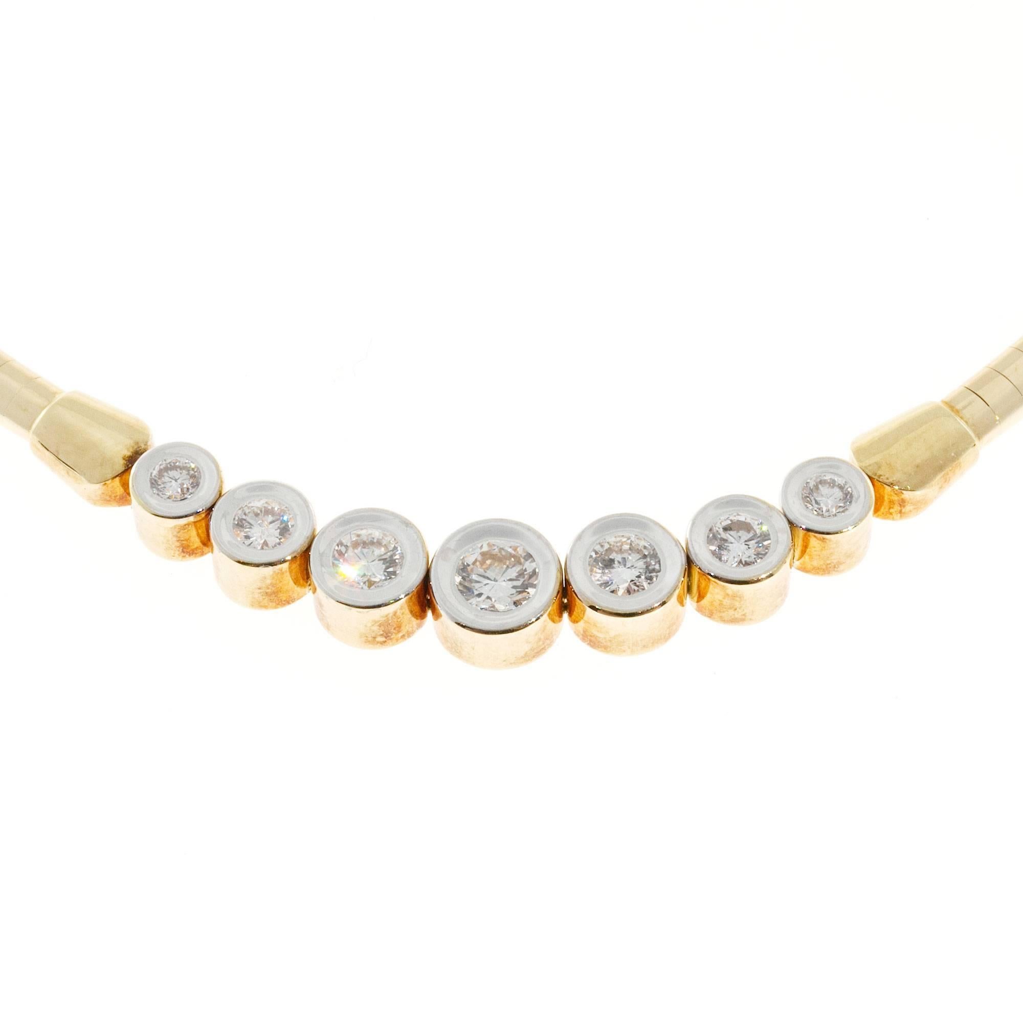 Domed 3mm 14k yellow gold omega chain with nice end caps and 7 hinged graduated tubes each set with a full cut diamond in a white gold top.

7 round diamonds approx. total weight .87cts, G, VS2-SI
14k yellow & white Gold
Stamped: 14k Italy
23.6