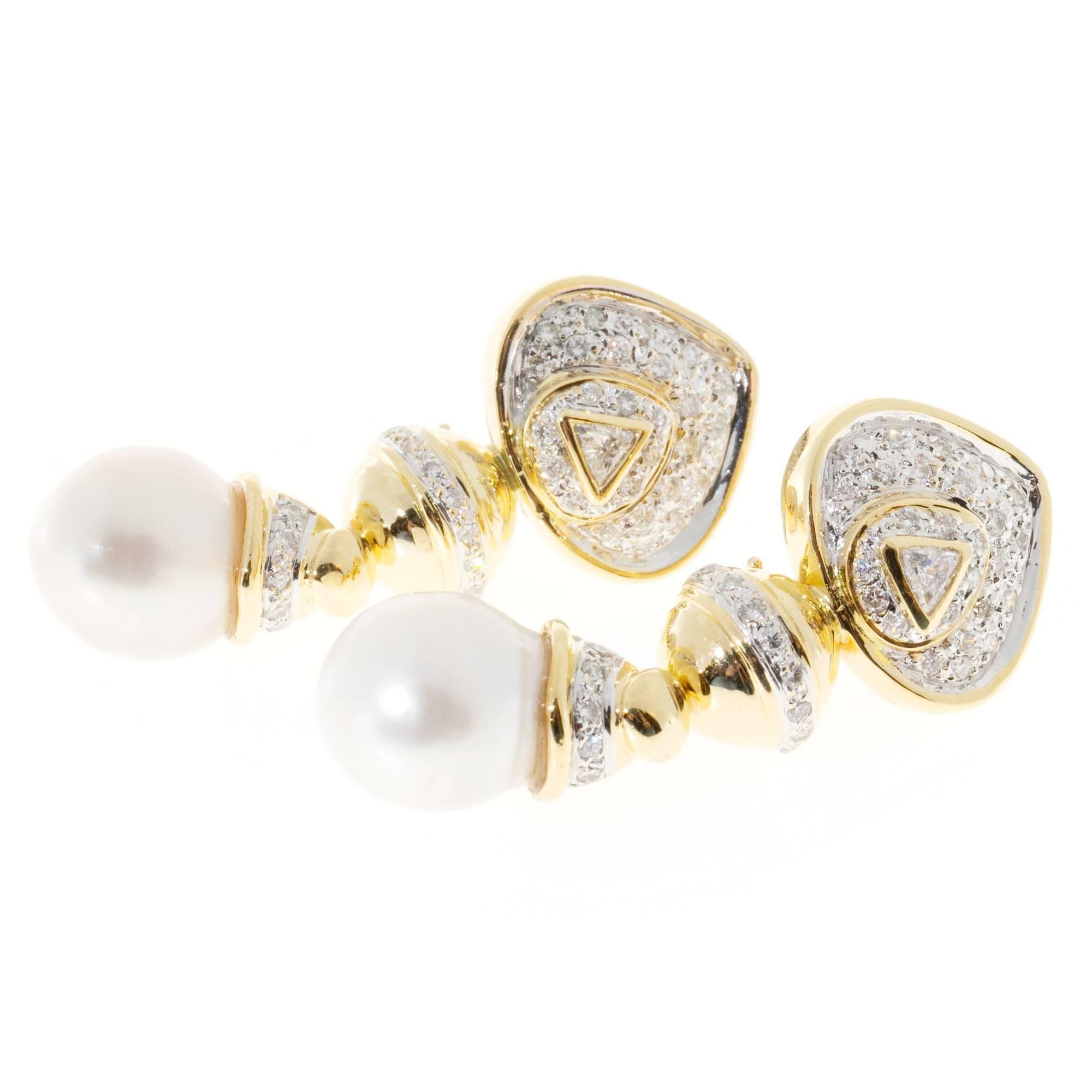 Diamond and South Sea cultured pearl yellow gold Clip and post style dangle earrings.

2 brilliant cut diamonds, approx. total weight .18cts, H, SI1
88 full cut diamonds, approx. total weight .75cts, H, SI1
2 South Sea cultured pearls 11mm,