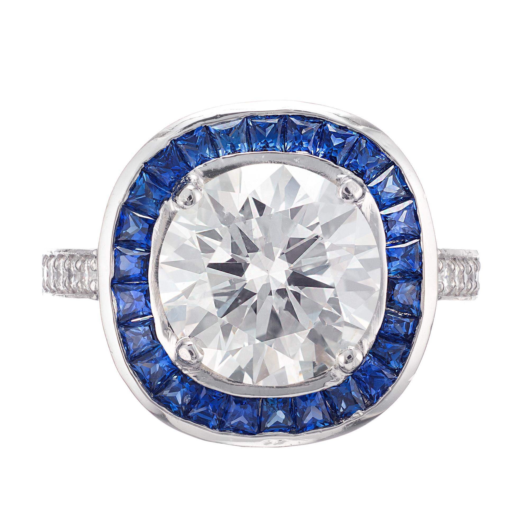Diamond and sapphire engagement ring. GIA certified 3.29 carat round brilliant cut center stone in a platinum setting with a halo of calibre ceylon Sapphires and round accent diamonds. 

1 Round brilliant cut Ideal diamond, approx. total weight