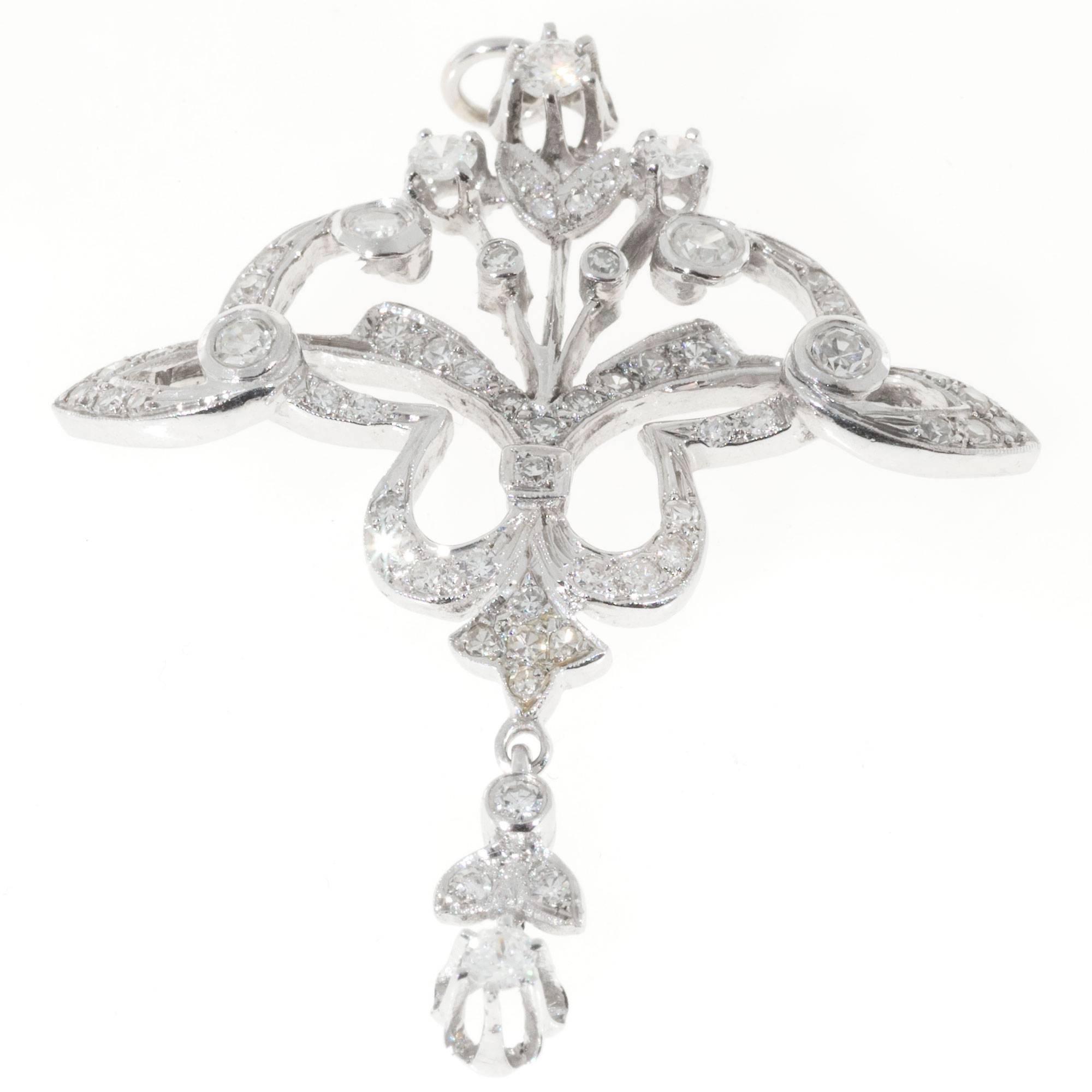 1940-1950 14k white gold pendant with fine white diamonds. Nice bead setting and open work.

58 round diamonds mixed full and single cut, F, VS, approx. total weight 1.05cts
14k White Gold
7.4 grams
Top to bottom: 1.91 inches or 48mm
Width: