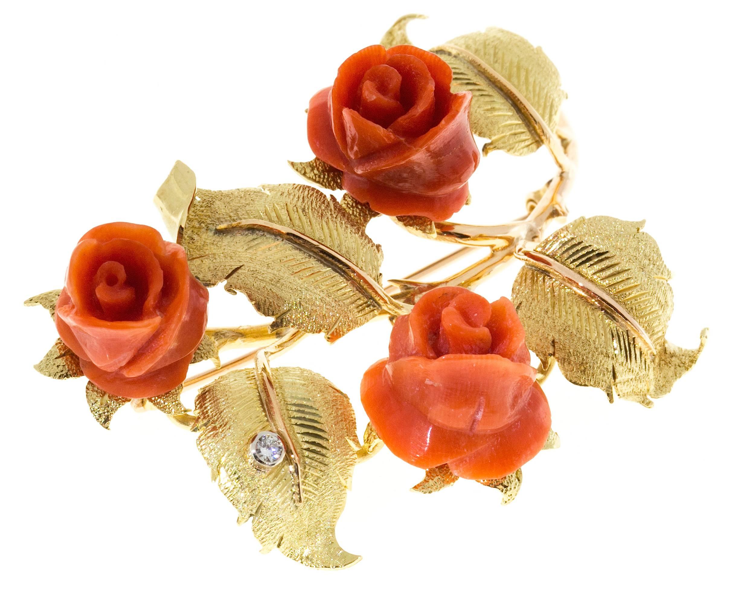 1950's handmade brooch with rose and green gold textured leaves. Genuine natural untreated carved Coral roses with one round diamond. 

1 full cut diamond approx. total weight .03cts, F, VS
3 genuine untreated Coral 16 x 12.5mm across and 12mm