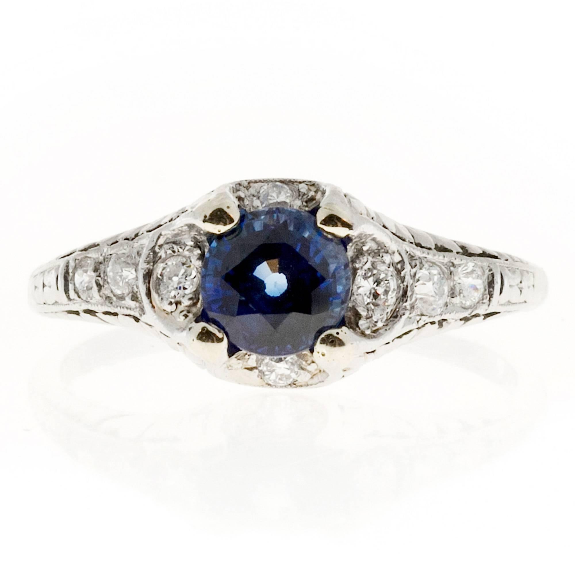 Handmade pierced engraved old cut sapphire and pave diamond engagement ring.  Circa 1910-1920.

1 round sapphire approx. total weight 1.05cts
8 round diamonds approx. total weight .14cts
Platinum
Tested Plat
4.3 grams
5/16 x ¾ inch
Size 7
