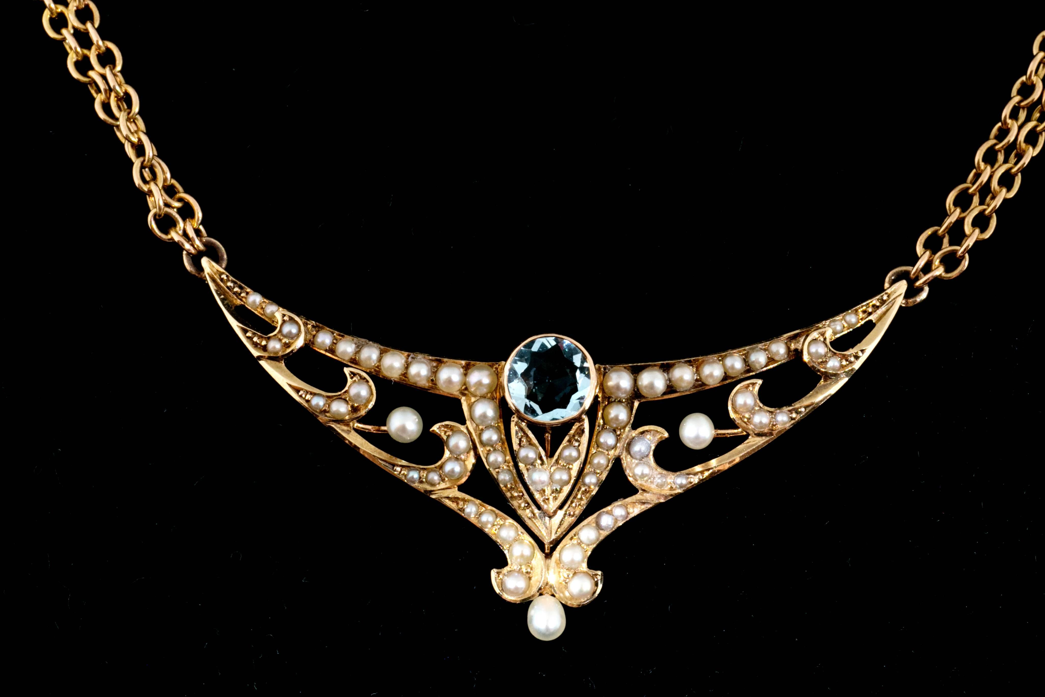 Handmade untreated Aquamarine natural pearl pendant and double chain. 18 ½ inch length. Circa 1890-1900

1 tear drop shaped pearl
1 round Aquamarine approx. total weight .75cts
44 seed pearls
(2) 2mm natural pearls
14k Yellow Gold
Stamped &