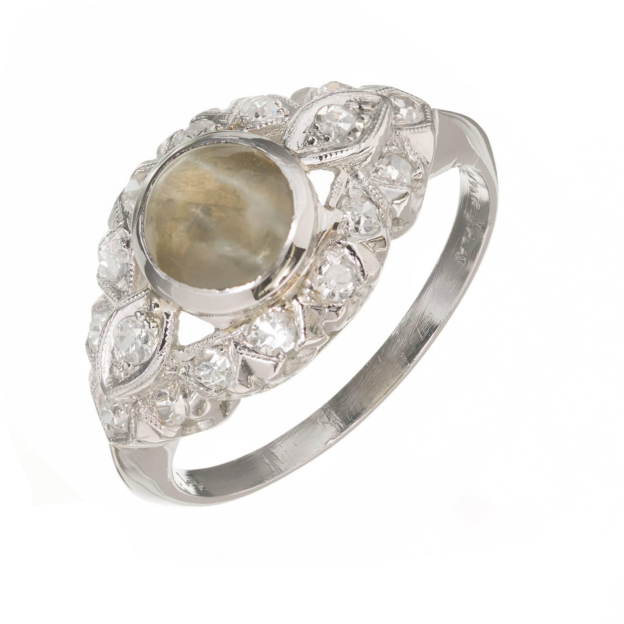 1920’s Art Deco diamond and chrysoberyl cat’s eye open work ring. Round chrysoberyl cats eye center stone with 16 round accent diamonds in a handmade platinum setting. 

1 round cabochon cut Chrysoberyl cat’s eye, 1.70cts
16 round diamonds approx.