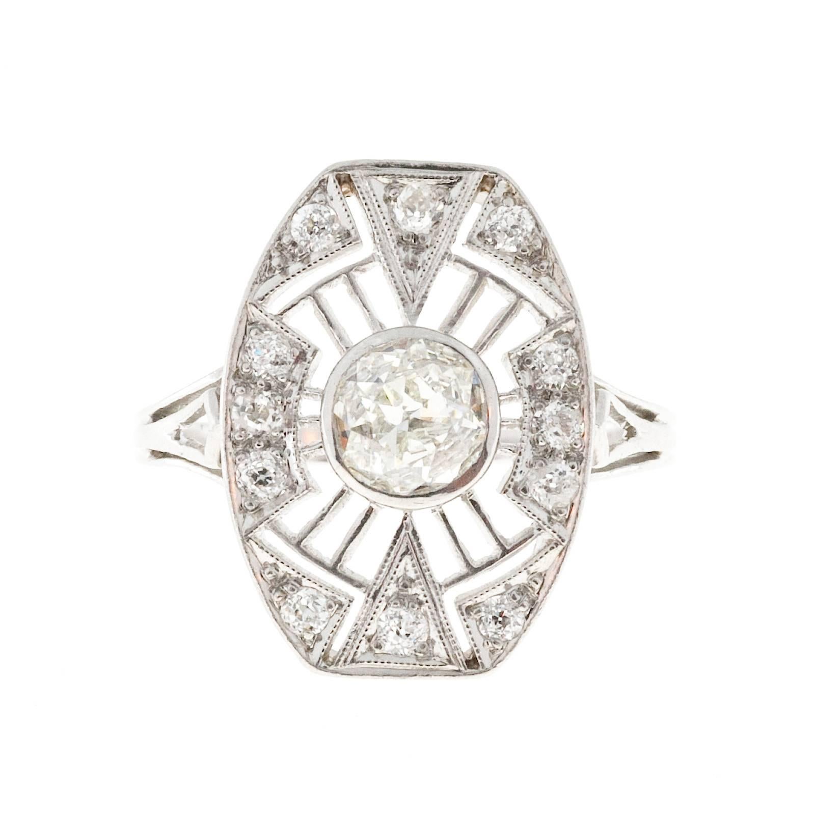 Circa 1905 Edwardian Raised crown and small table, platinum diamond ring. 

1 round brilliant cut diamond, approx. total weight .52cts, H-I, VS1, 5.50 x 5.45 x 2.55mm, Depth: 46.5%, Table: 51%, 
12 brilliant cut diamonds, approx. total weight