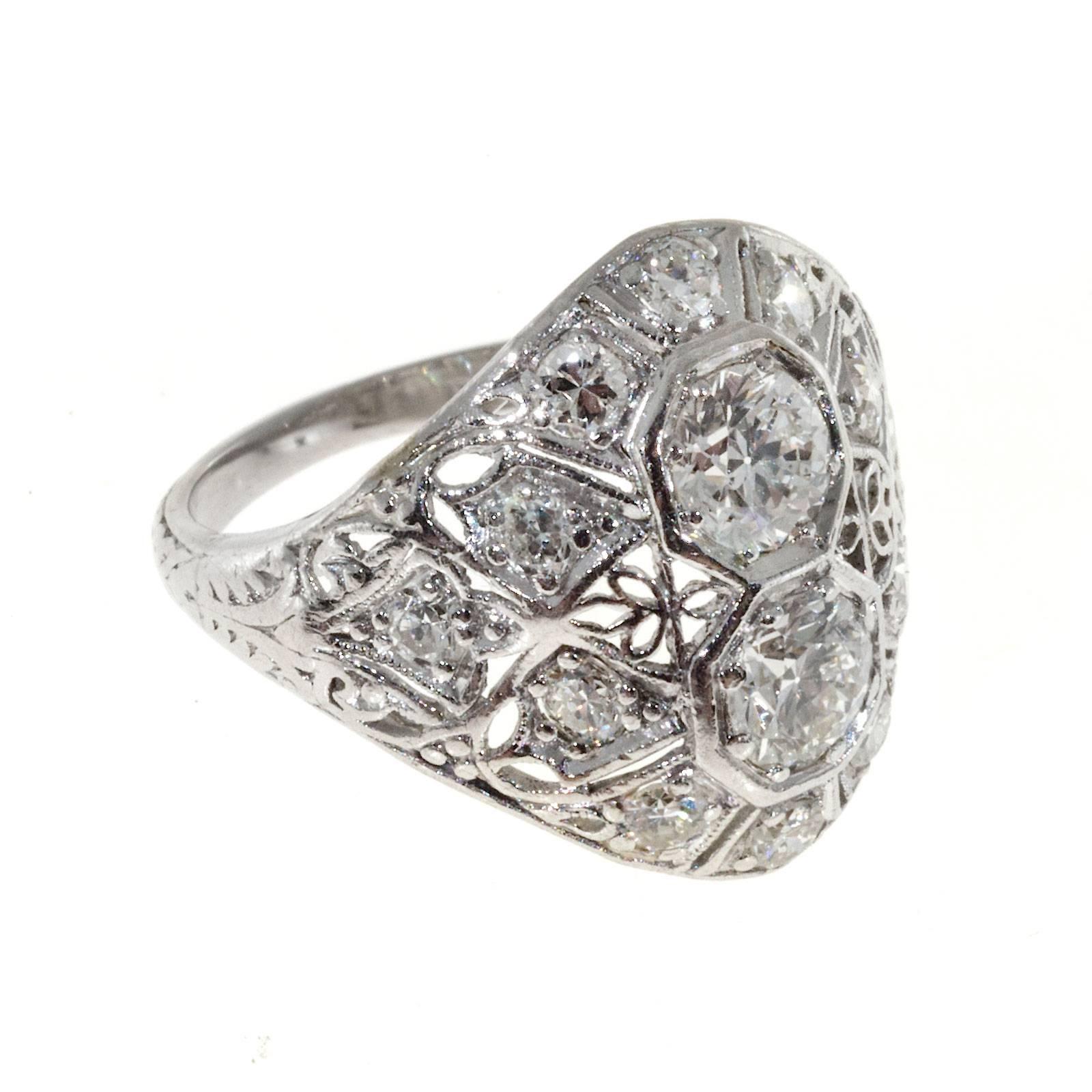 Art Deco handmade diamond dome ring circa 1930's. Hand pierced and hand engraved. 

2 European cut diamonds, approx. total weight .66cts, F, VS2
12 full cut round diamonds, approx. total weight .22cts, F, VS2
Platinum
Tested: Platinum
Stamped: