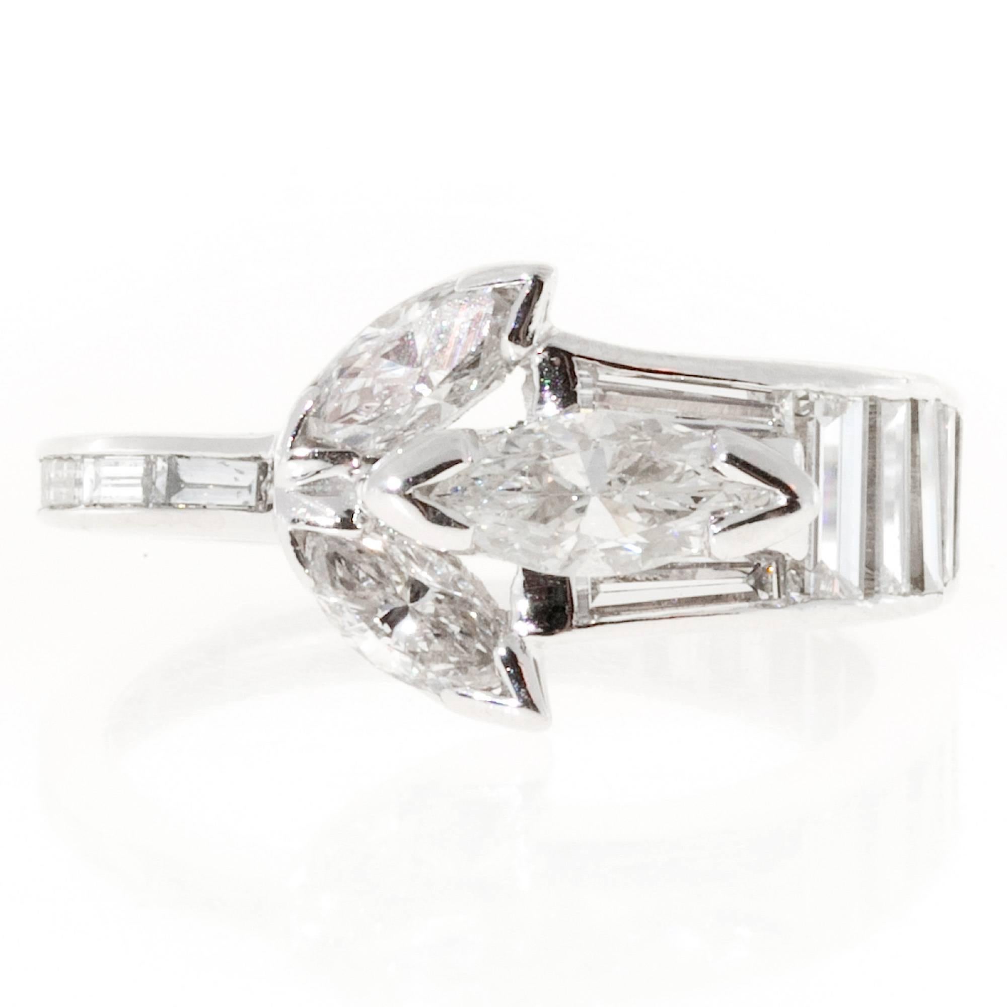 1.35 carat Marquise Baguette Diamond platinum ring.

3 Marquise diamonds, approx. total weight .55cts, F-G, VS
19 Baguette cut diamonds, approx. total weight .80cts F-G, VS
Size 3 and not sizable
Platinum
Platinum 950
Tested: Platinum
Stamped: