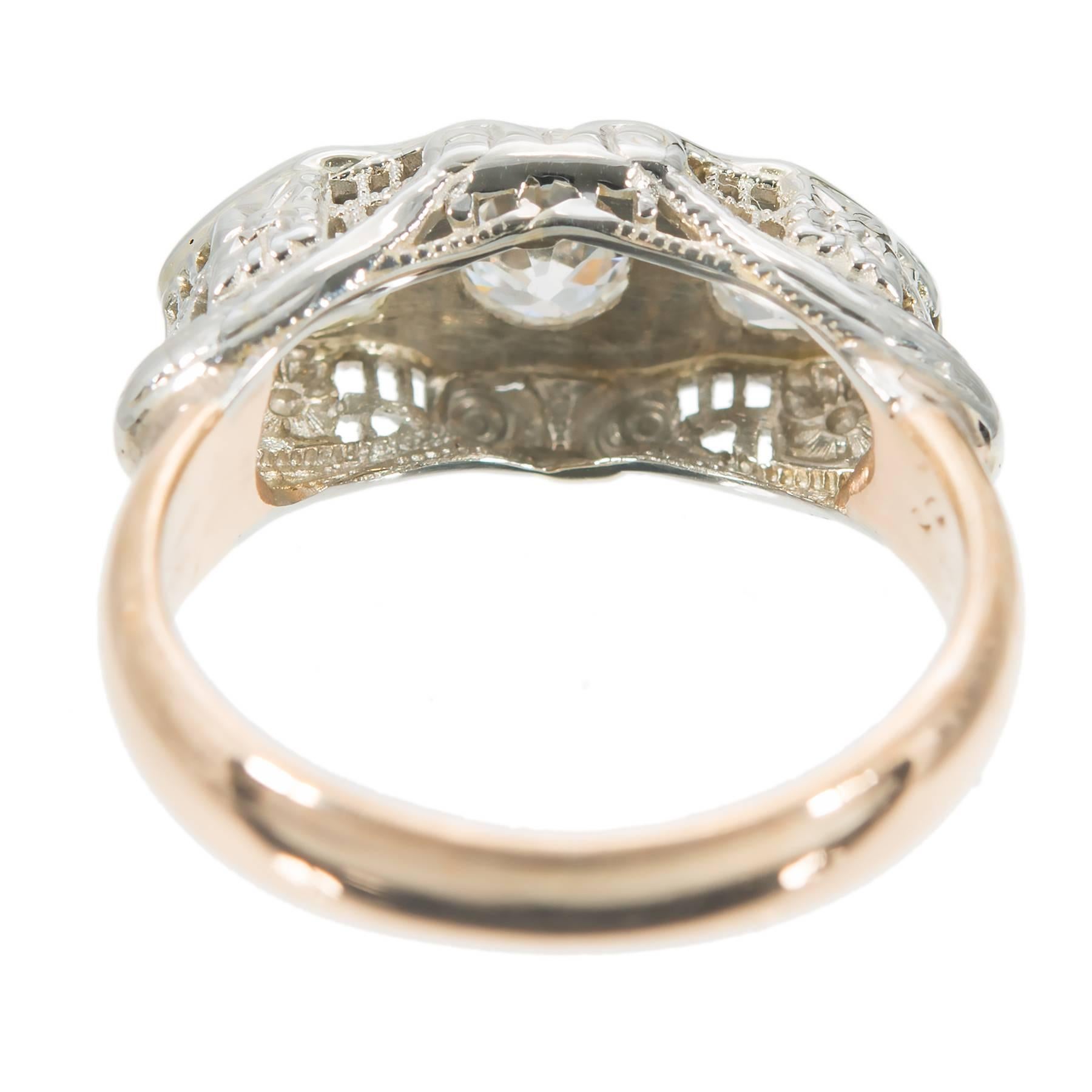 1920's white and yellow gold filigree engagement ring with old mine original diamonds.

3 old mine cut diamonds. Center approx. total weight .33cts, cushion cut. Sides: .21cts each, I to J, VS. Total of all .75cts.
14k White Gold
14k Rose Gold
Top